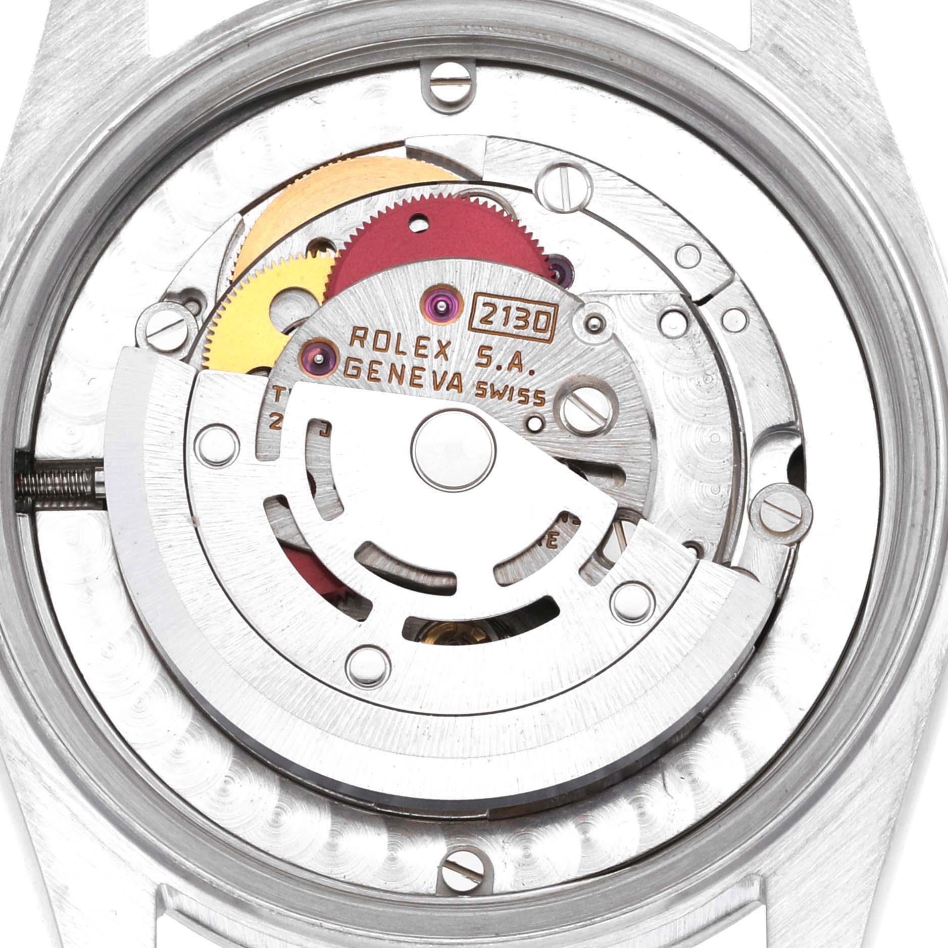 The image shows the movement mechanism of a Rolex Mid-Size 67480 Women's Stainless Steel Black Dial 67480 Women's Stainless Steel Black Dial model watch, highlighting internal components and gears.