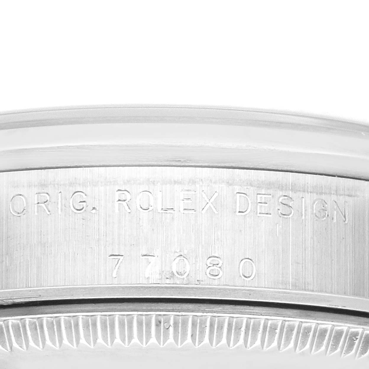 This image shows a close-up side view of a Rolex Mid-Size 77080 Women's Stainless Steel Black Dial 77080 Women's Stainless Steel Black Dial model, highlighting the engraved design details.