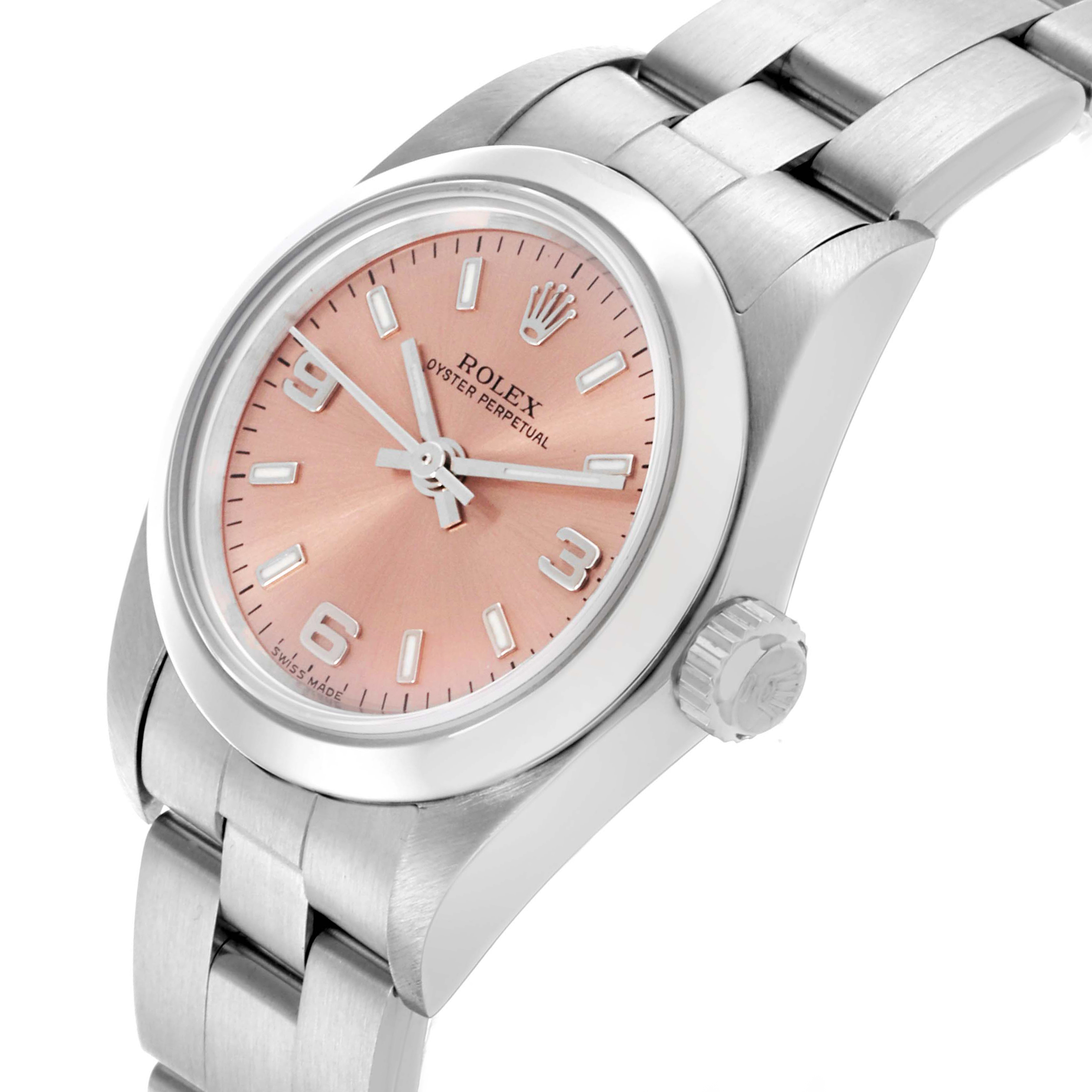 The Rolex Oyster Perpetual 76080 Women's Stainless Steel Pink Dial 76080 Women's Stainless Steel Pink Dial is shown from an angled side, displaying the dial, bezel, crown, and part of the bracelet.