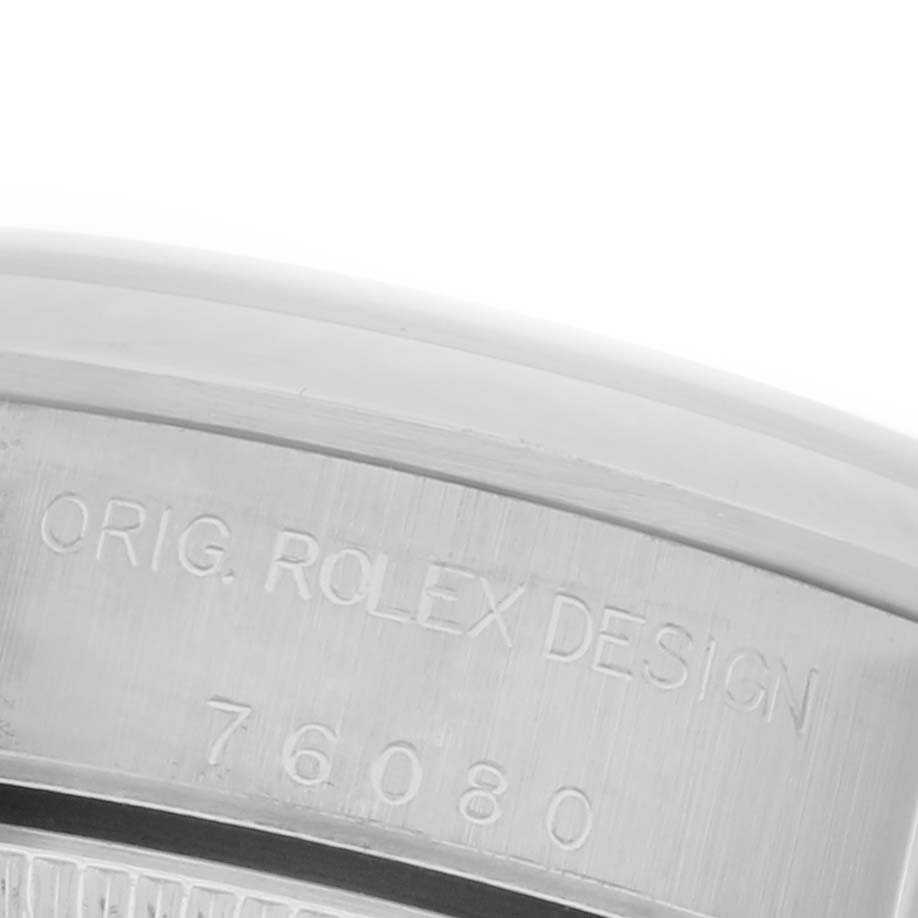 The image shows a close-up of the engraved inner bezel of a Rolex Oyster Perpetual 76080 Women's Stainless Steel Pink Dial 76080 Women's Stainless Steel Pink Dial watch.