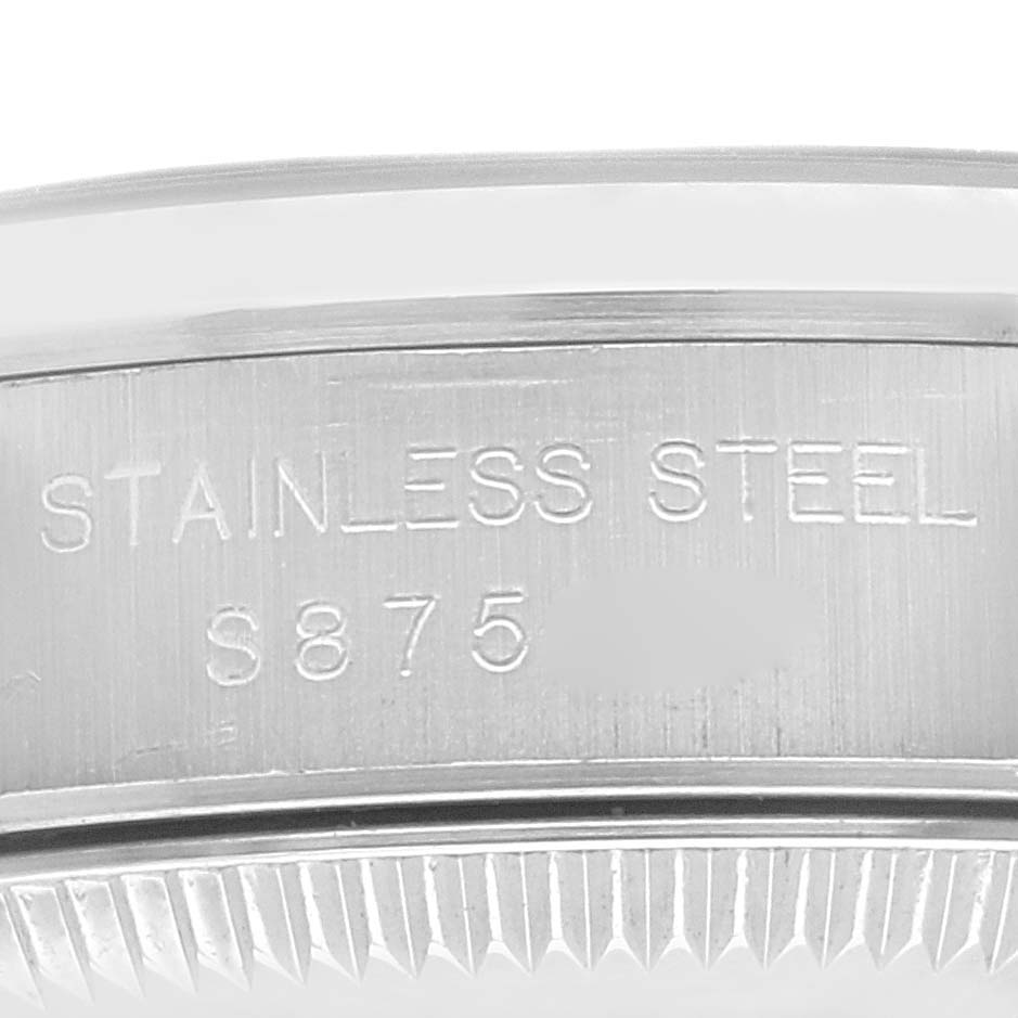 This image shows a close-up view of the engravings and edge of the case back of a Rolex Oyster Perpetual 67180 Women's Stainless Steel Black Dial 67180 Women's Stainless Steel Black Dial watch.