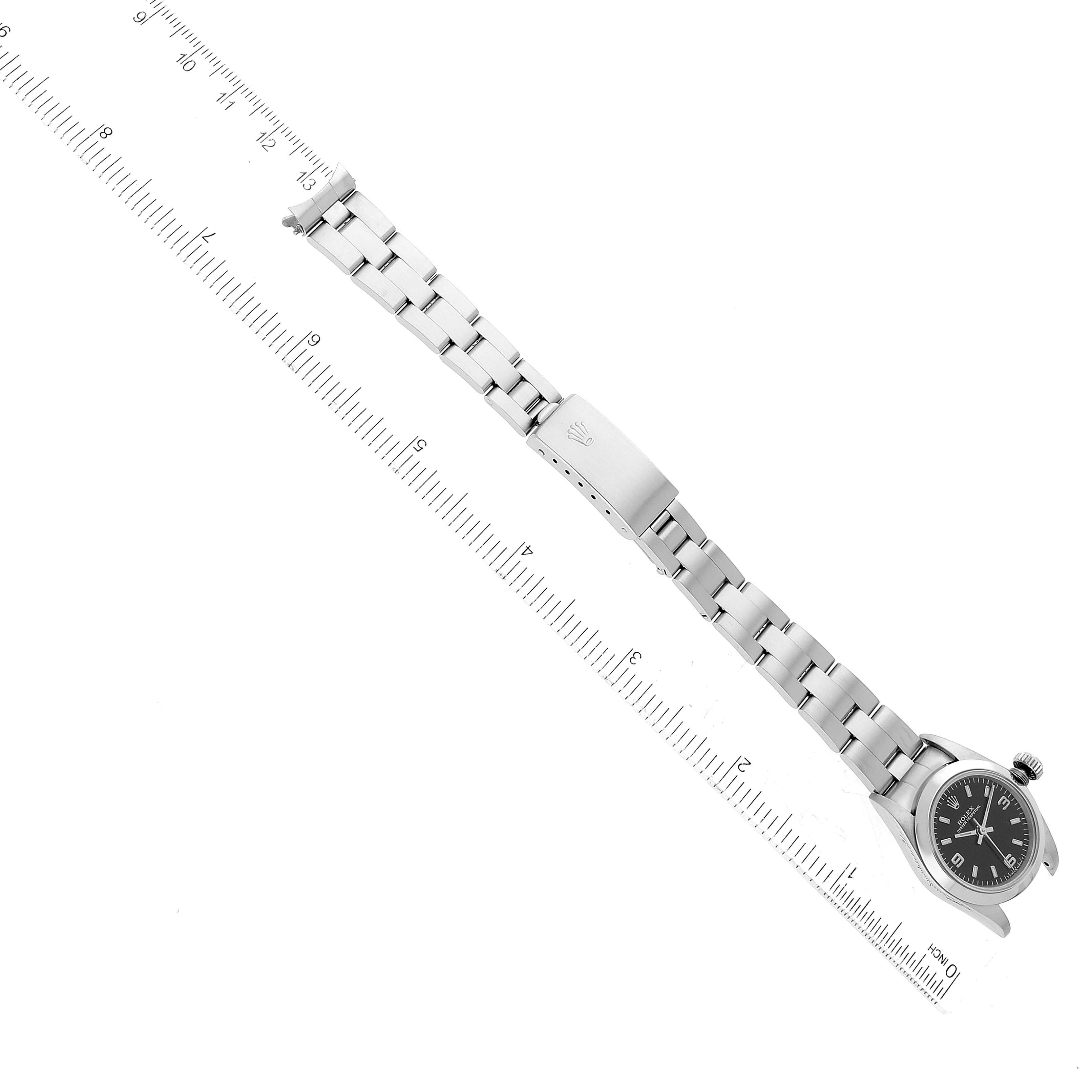 The image shows a top-down angle of a Rolex Oyster Perpetual 67180 Women's Stainless Steel Black Dial 67180 Women's Stainless Steel Black Dial watch, including its face and stainless steel bracelet.