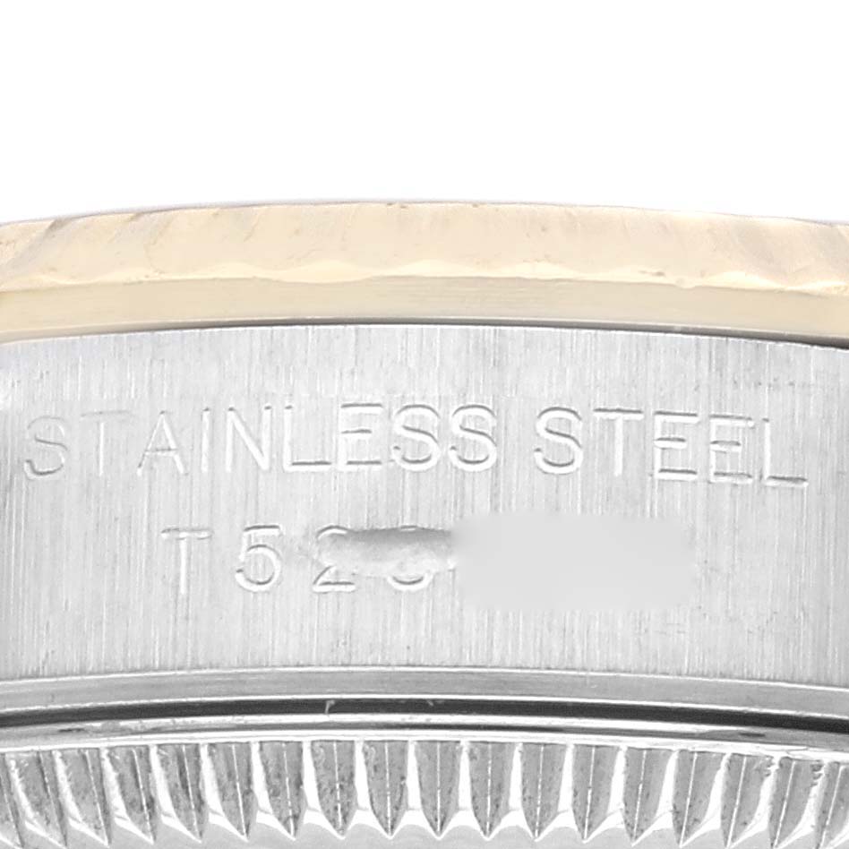 This image shows a close-up of the side of the stainless steel case of a Rolex Oyster Perpetual 67193 Women's Steel and Gold (two tone) Champagne Dial 67193 Women's Steel and Gold (two tone) Champagne Dial watch, including the serial number.