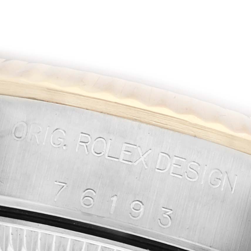 The image shows a close-up of the side of a Rolex Oyster Perpetual 76193 Women
s Steel and Gold (two tone) White Dial 76193 Women
s Steel and Gold (two tone) White Dial watch, highlighting the "Orig. Rolex Design" engraving.