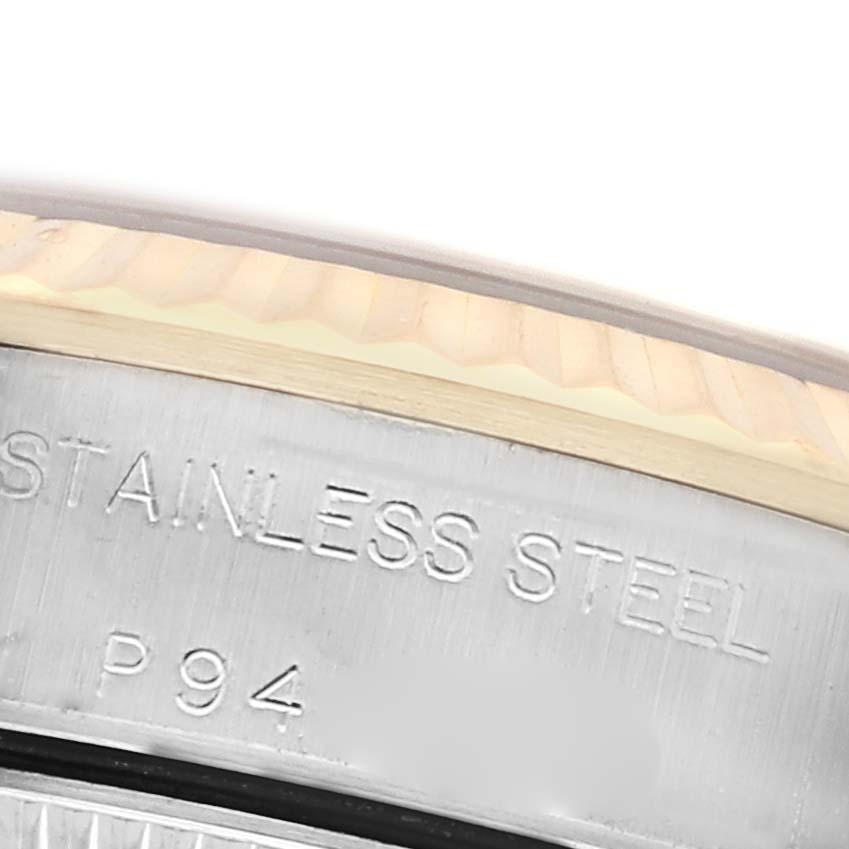 The image shows a close-up of the engraved stainless steel part of the Rolex Oyster Perpetual 76193 Women
s Steel and Gold (two tone) White Dial 76193 Women
s Steel and Gold (two tone) White Dial watch case.