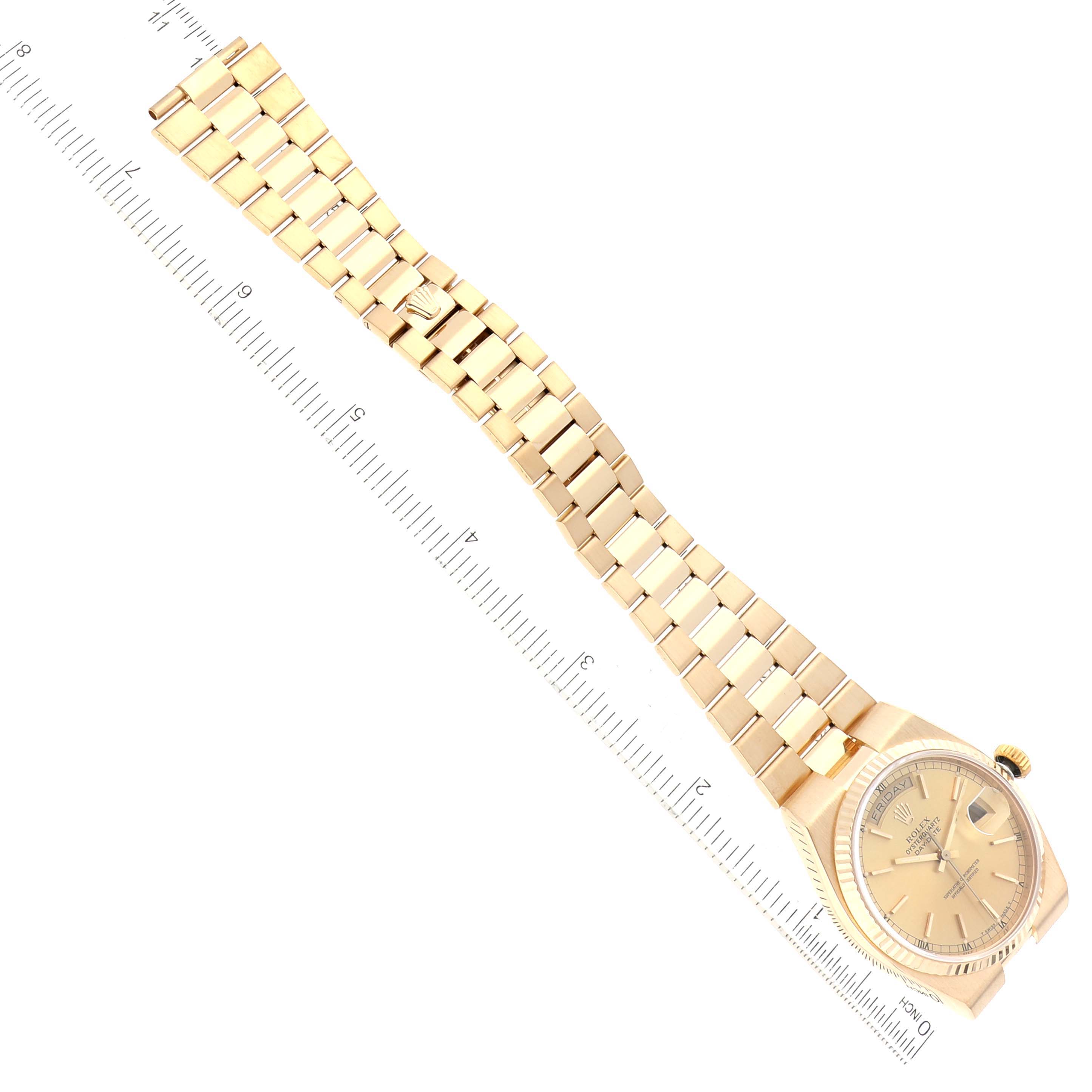 The image shows a top-down view of a Rolex Oysterquartz 19018 Men's Yellow Gold Champagne Dial 19018 Men's Yellow Gold Champagne Dial watch, displaying the face, bezel, and full bracelet, alongside a ruler for scale.