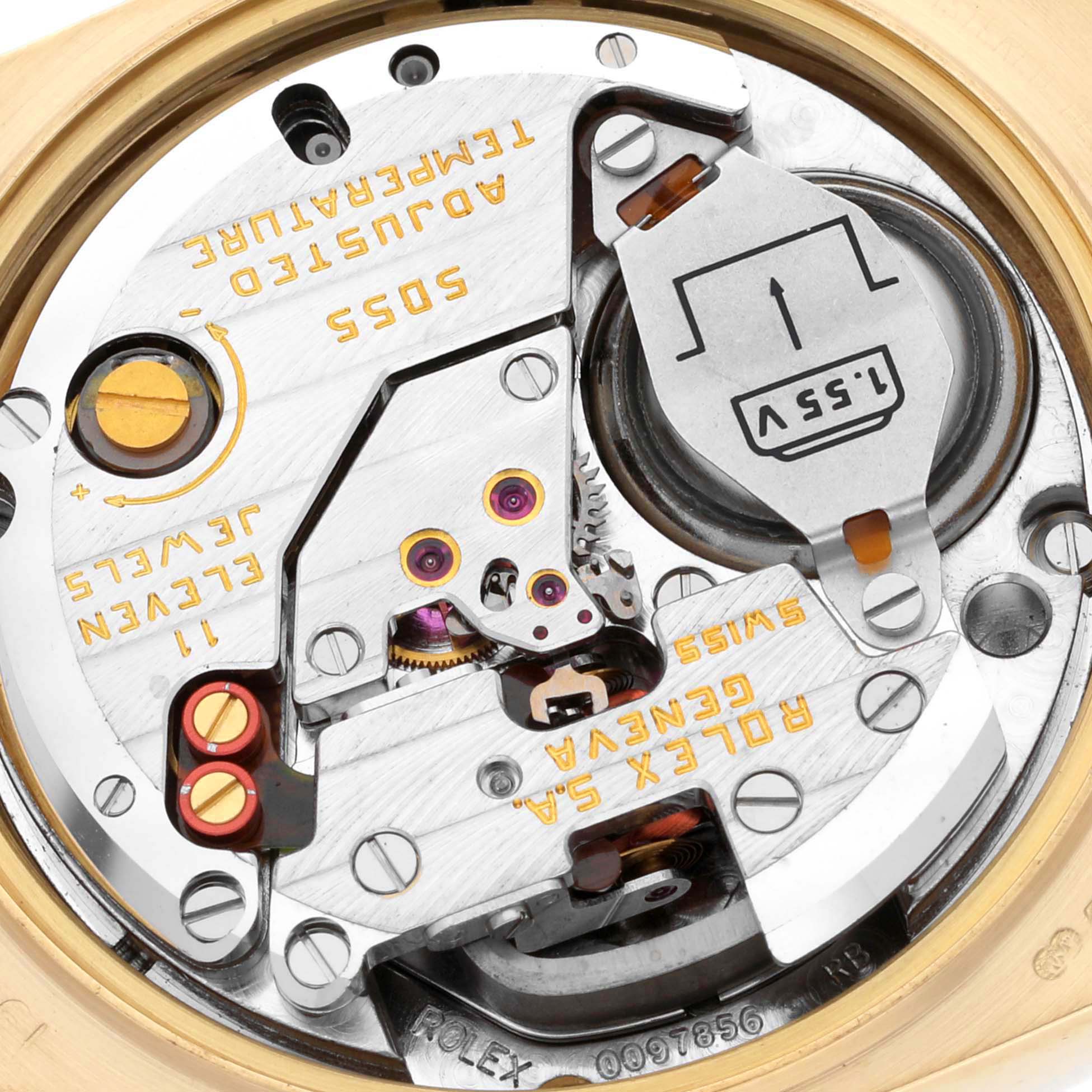 The image shows the intricate inner mechanism of the Rolex Oysterquartz 19018 Men's Yellow Gold Champagne Dial 19018 Men's Yellow Gold Champagne Dial watch model focusing on the battery and movement components.
