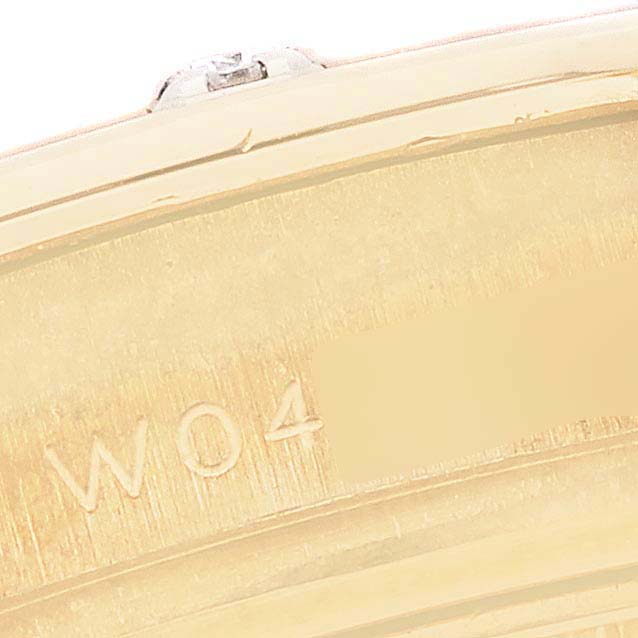 The image shows a close-up of the Rolex Pearlmaster 69318 Women's Yellow Gold Silver Dial 69318 Women's Yellow Gold Silver Dial watch's gold band with an engraved number and partial side view.
