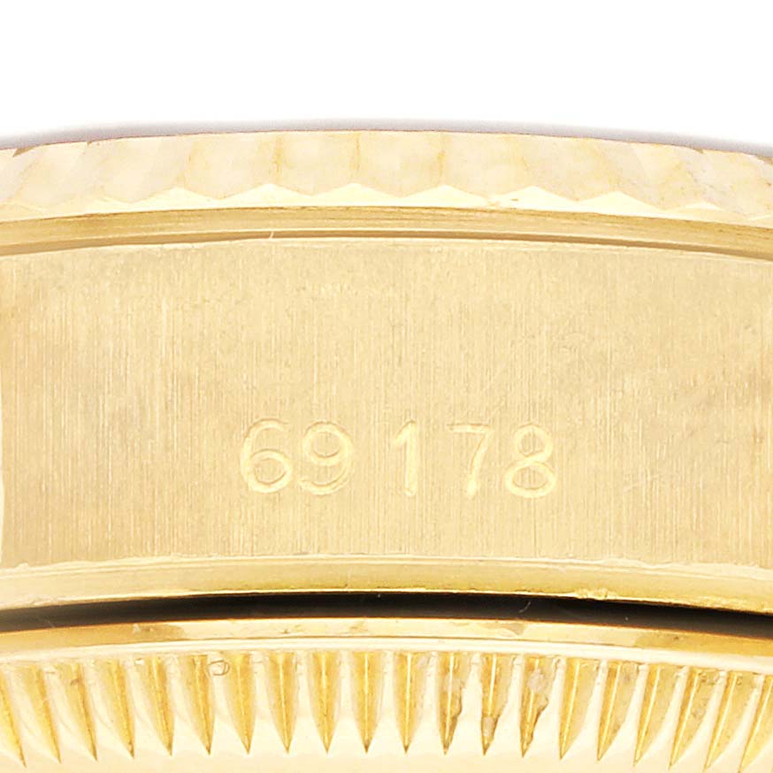 The image shows a close-up of the side of a Rolex President 69178 Women's Yellow Gold White Dial 69178 Women's Yellow Gold White Dial model, focusing on the bezel and engraved reference number.