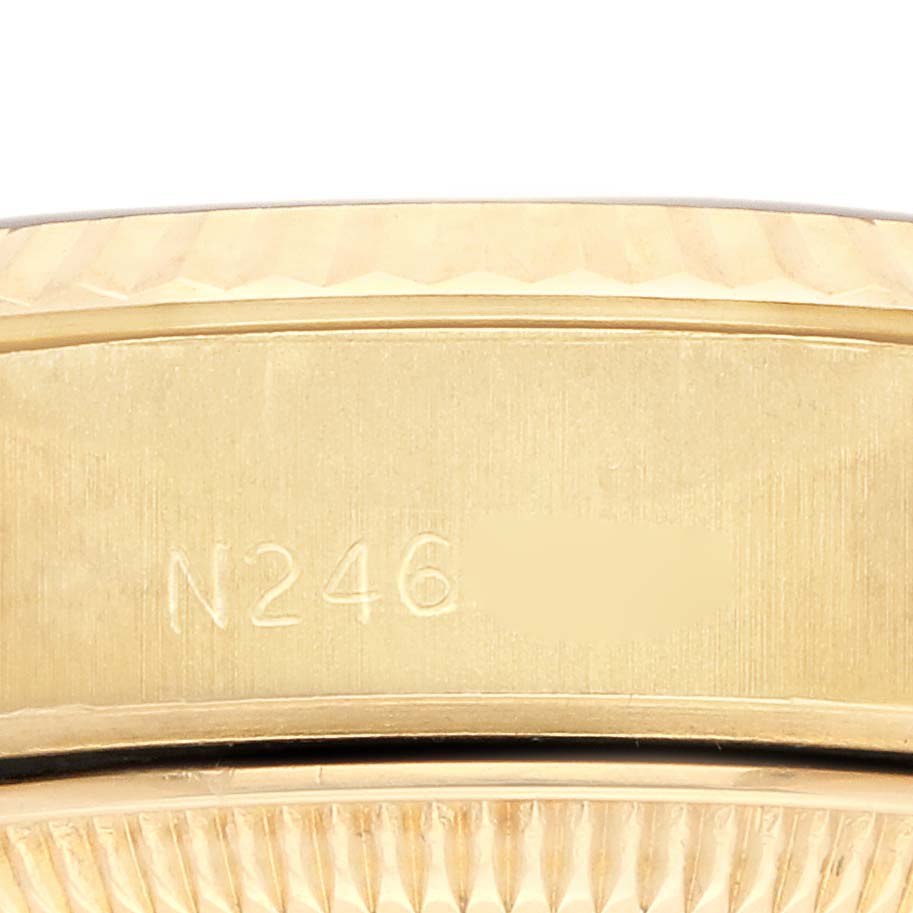 The image shows a close-up of the side of a Rolex President 69178 Women's Yellow Gold White Dial 69178 Women's Yellow Gold White Dial model watch, focusing on the gold band with engraved markings.
