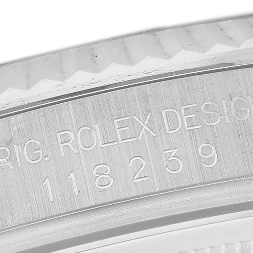 The image shows a close-up of the Rolex President 118239 Men's White Gold Mother of Pearl Dial 118239 Men's White Gold Mother of Pearl Dial model's engraved case edge, featuring the design number.