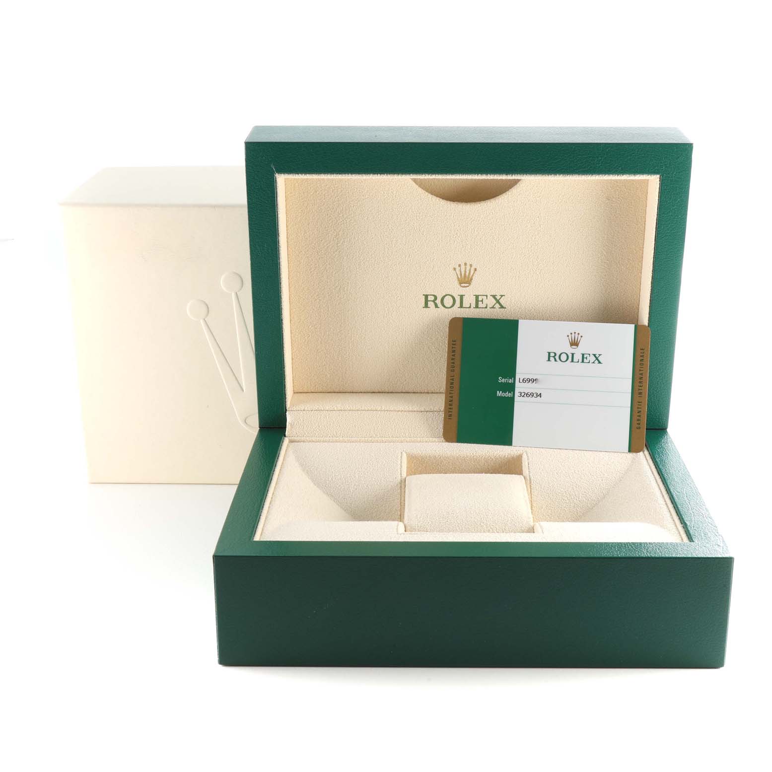 The image shows the open box of a Rolex Sky-Dweller 326934 Men
s Stainless Steel Black Dial 326934 Men
s Stainless Steel Black Dial watch, including the warranty card and an empty slot where the watch resides.