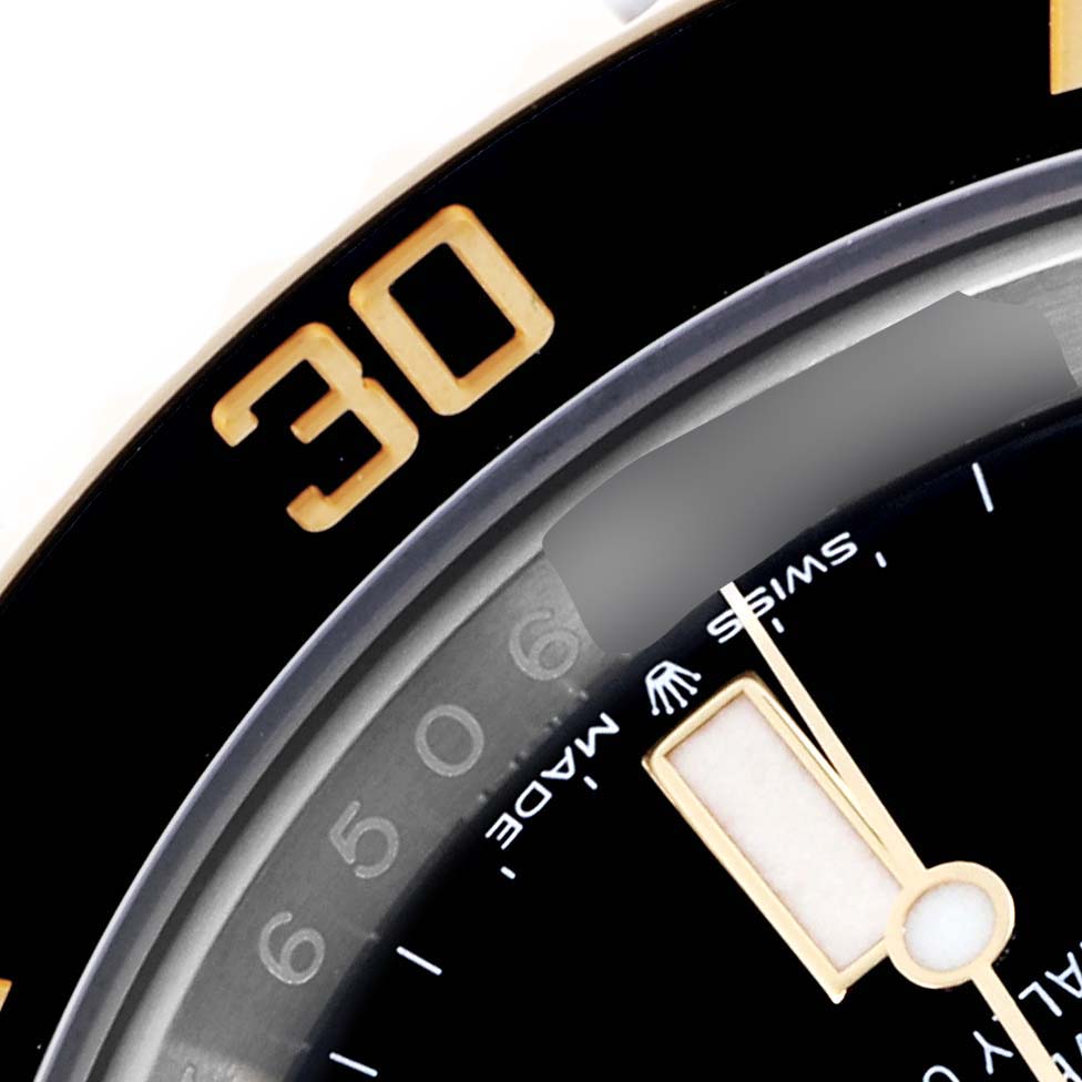 The image shows a close-up of the Rolex Submariner 126613LN Men's Steel and Gold (two tone) Black Dial 126613LN Men's Steel and Gold (two tone) Black Dial bezel and part of the dial with gold accents.