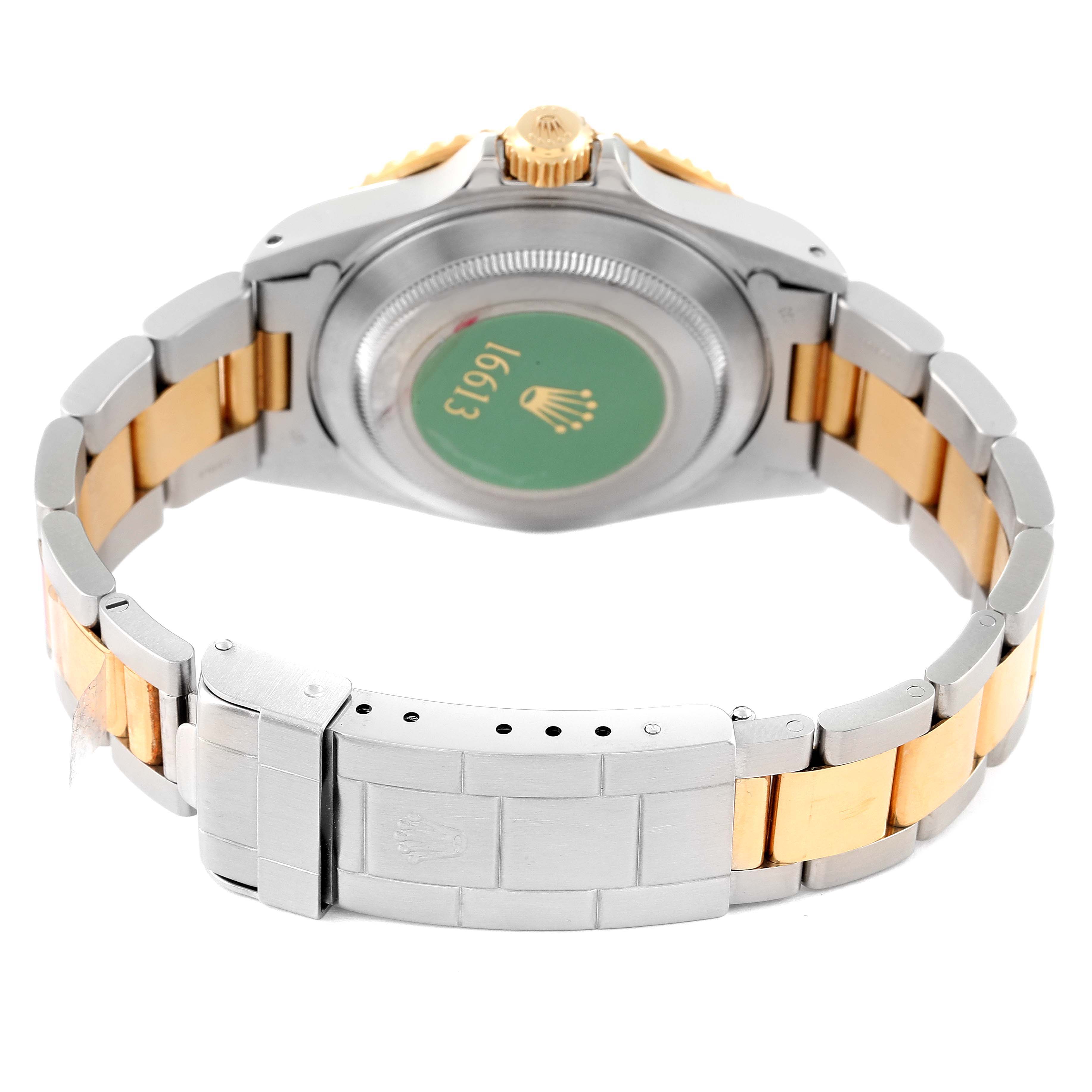 The image shows the back side of the Rolex Submariner 16613 Men's Steel and Gold (two tone) Blue Dial 16613 Men's Steel and Gold (two tone) Blue Dial watch, including the caseback and the two-tone bracelet with the clasp.