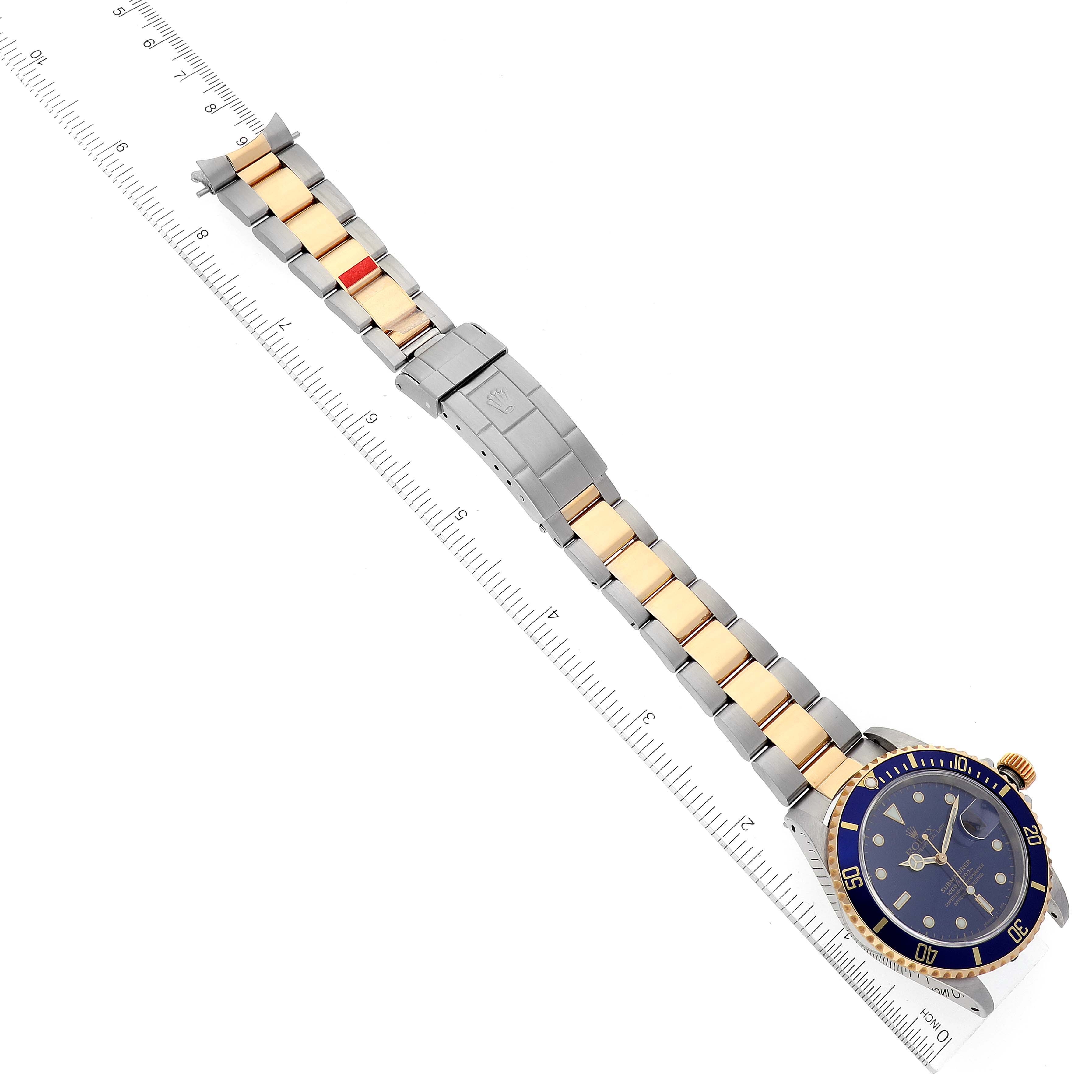 The image shows a top-down view of a Rolex Submariner 16613 Men's Steel and Gold (two tone) Blue Dial 16613 Men's Steel and Gold (two tone) Blue Dial watch, focusing on the band, face, and bezel.