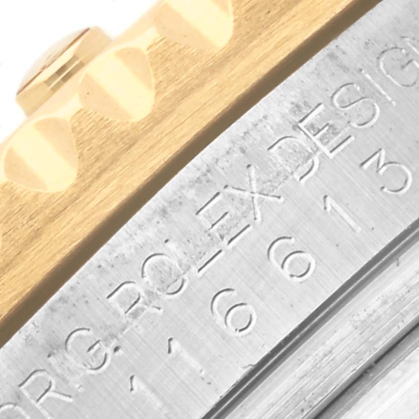 This close-up image shows part of the Rolex Submariner 116613LB Men's Steel and Gold (two tone) Blue Dial 116613LB Men's Steel and Gold (two tone) Blue Dial watch, detailing the engraved "ORIG ROLEX DESIGN" on the case back.