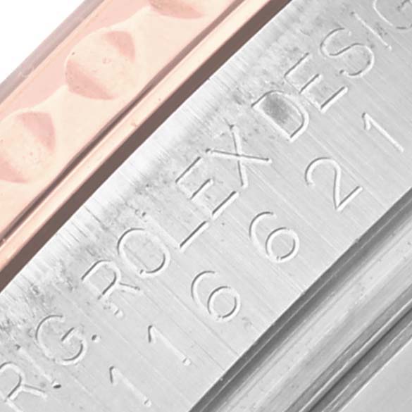 The image shows a close-up of the Rolex Yacht-Master 116621 Men's Steel and Gold (two tone) Brown Dial 116621 Men's Steel and Gold (two tone) Brown Dial watch edge, highlighting engravings and part of the bracelet.