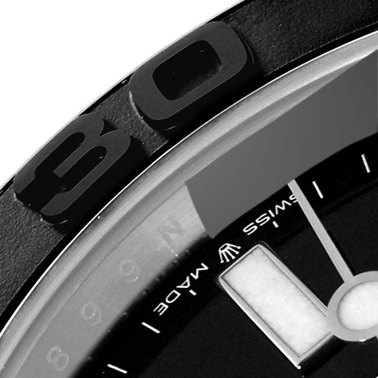 This close-up angle of the Rolex Yacht-Master 226659 Men's White Gold Black Dial 226659 Men's White Gold Black Dial watch shows part of the bezel, the dial, and an hour marker.