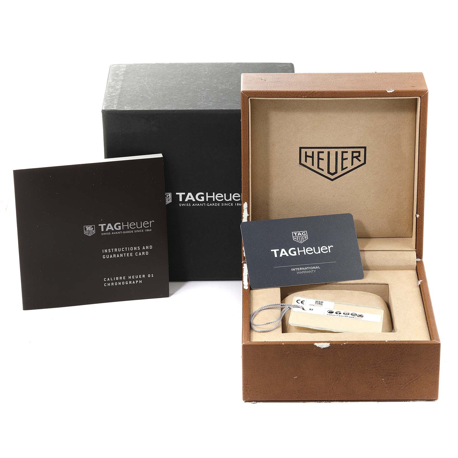 The image displays the box, instruction manual, and warranty card for a Tag Heuer Carrera CAR201T Men's Stainless Steel Blue Dial CAR201T Men's Stainless Steel Blue Dial watch.