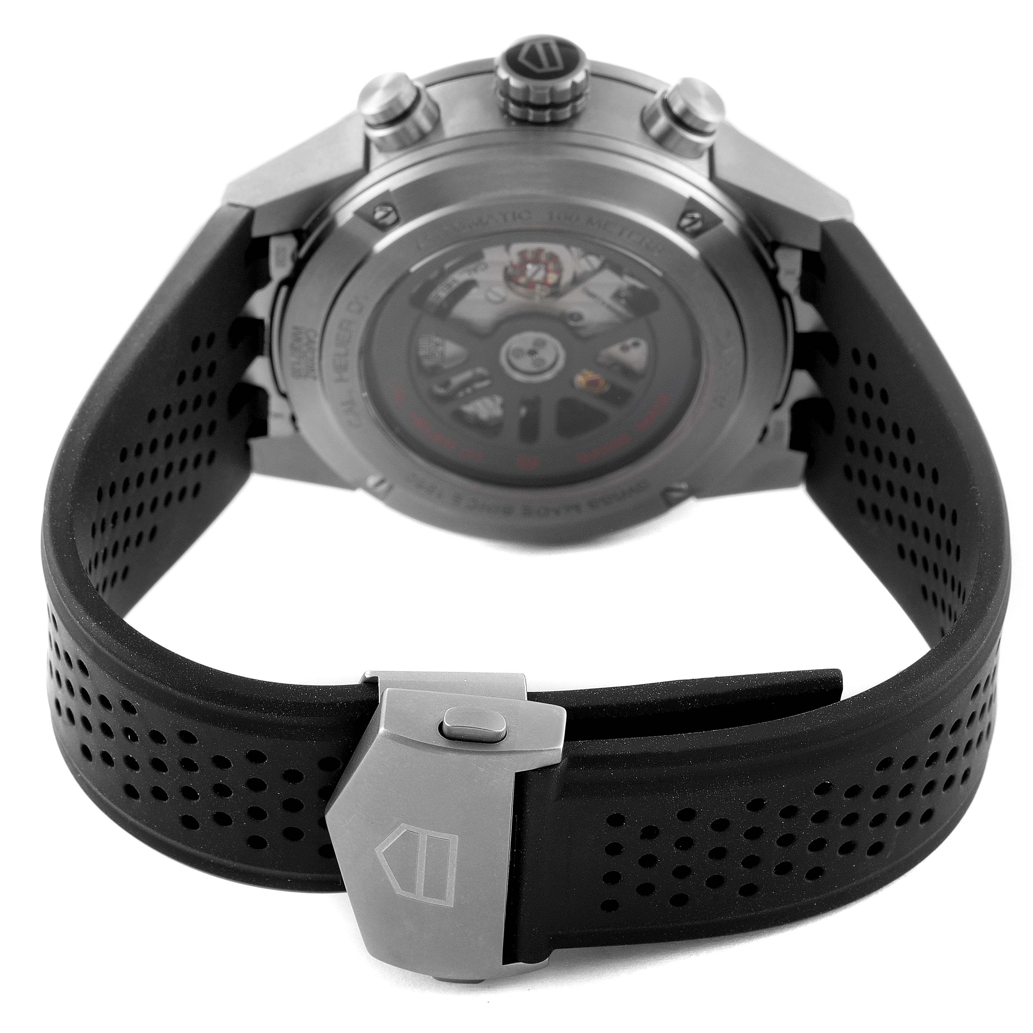 The image shows the rear view of a Tag Heuer Carrera CAR208Z.BF0719 Men's Stainless Steel Grey Dial CAR208Z.BF0719 Men's Stainless Steel Grey Dial model watch with focus on its back case, crown, and perforated black strap.