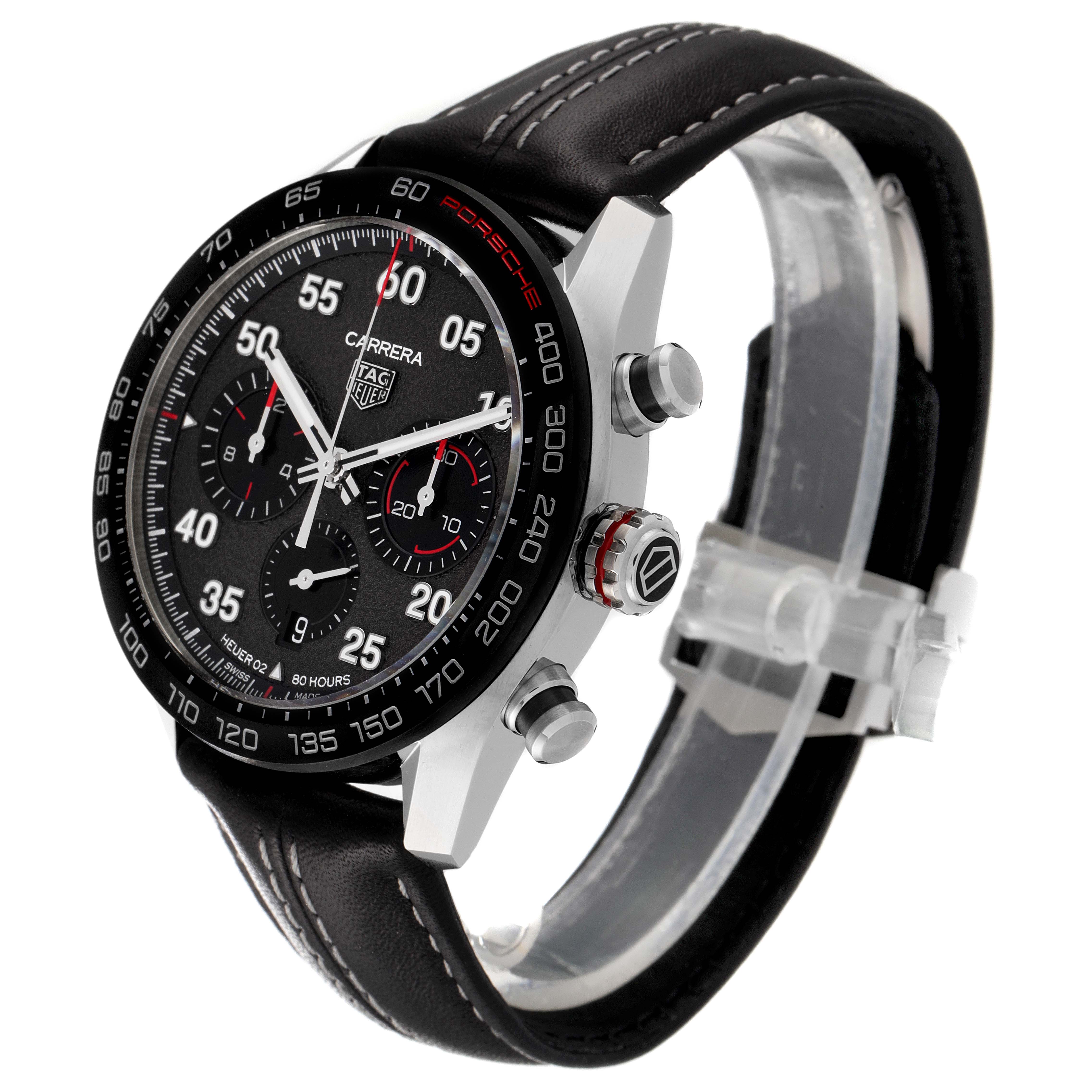 The Tag Heuer Carrera watch is shown at an angle displaying its face, side buttons, and part of the leather strap.