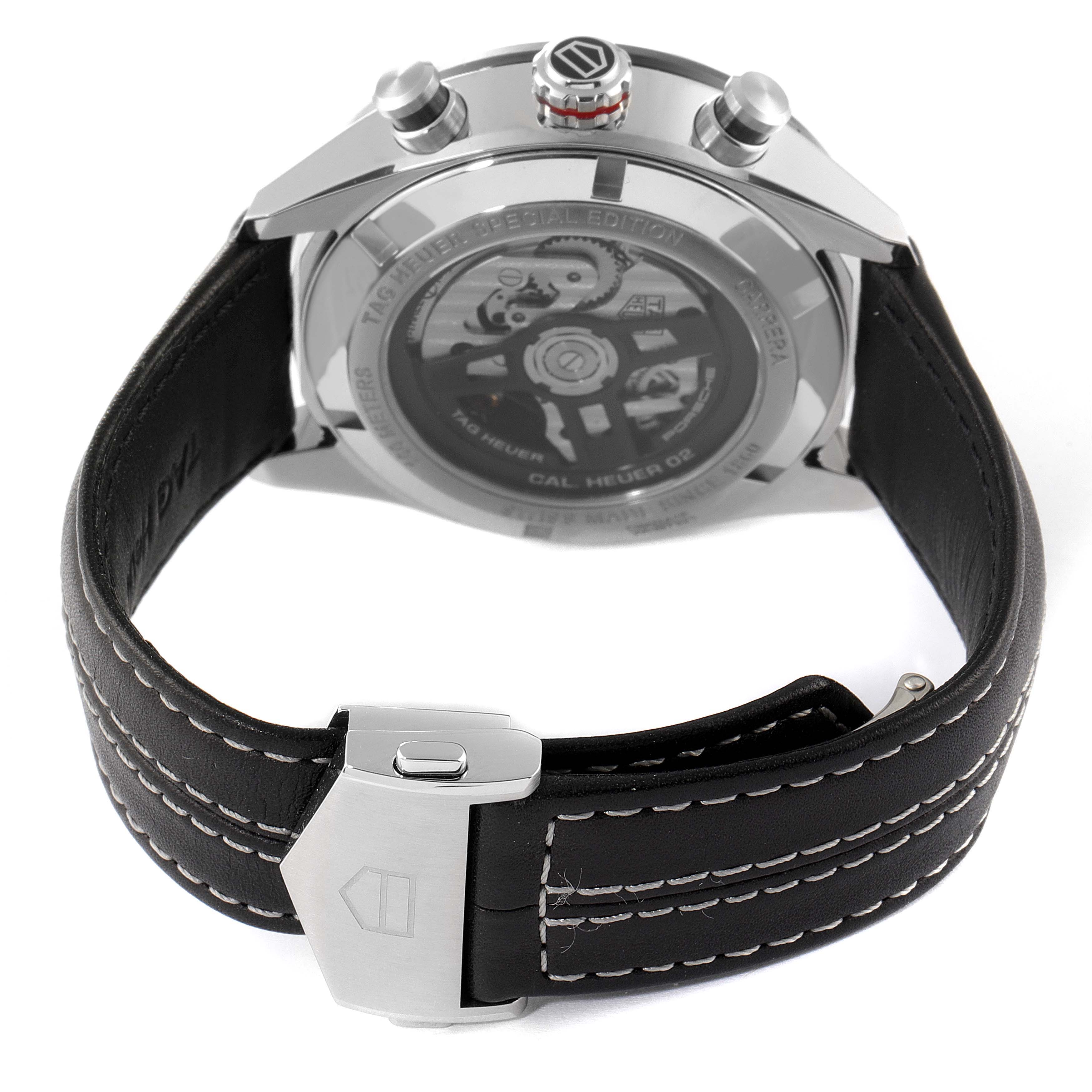 This image shows the back view of a Tag Heuer Carrera watch, highlighting the leather strap, clasp, and the watch's mechanical movement.
