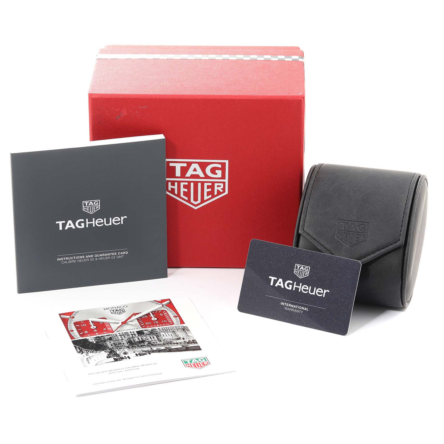 The image shows the packaging and accessories for the Tag Heuer Monaco CBL2114.FC6486 Men's Stainless Steel Red Dial CBL2114.FC6486 Men's Stainless Steel Red Dial watch, including the box, guarantee card, and instruction booklet.