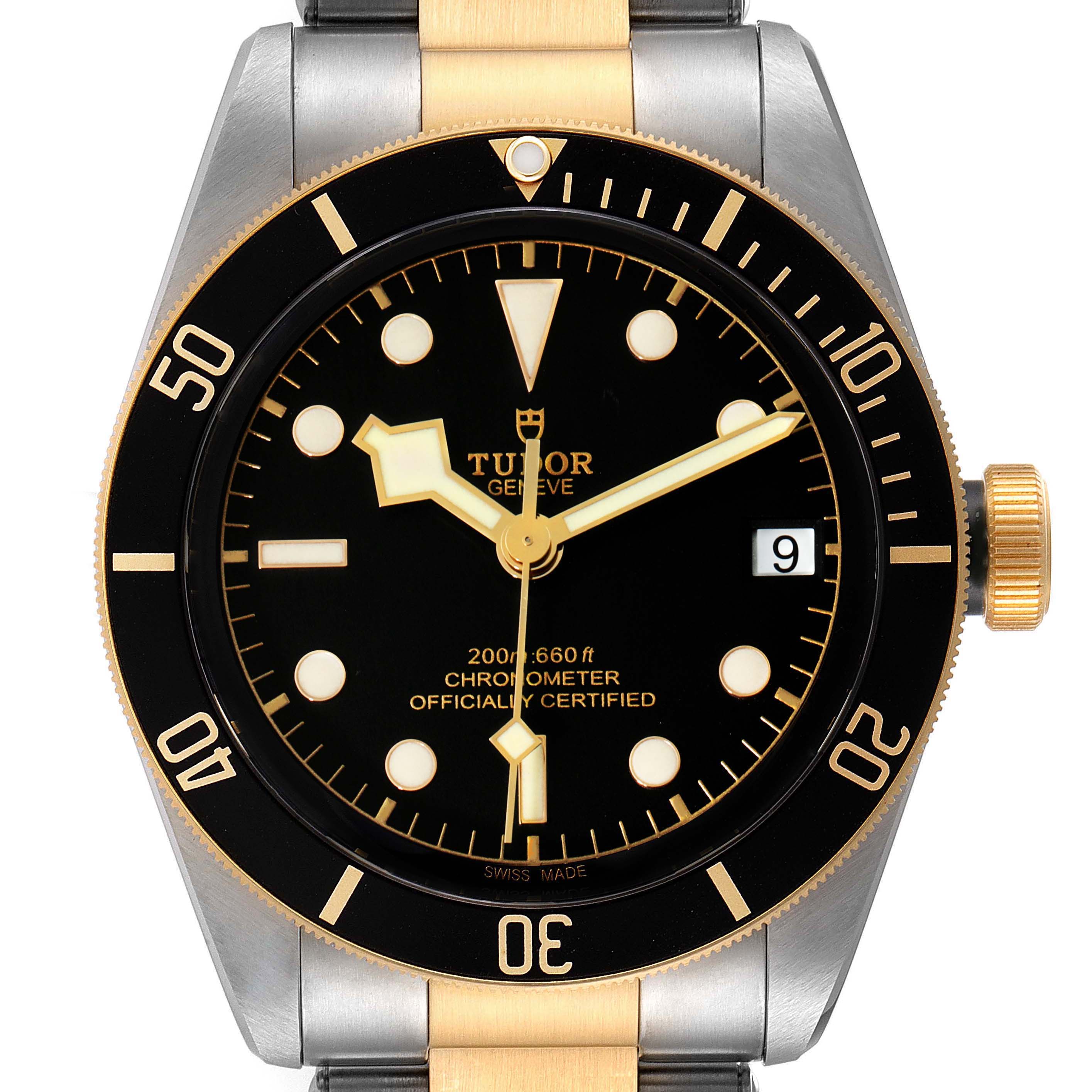 The image shows a front view of the Tudor Heritage Black Bay 79733 Men's Steel and Gold (two tone) Black Dial 79733 Men's Steel and Gold (two tone) Black Dial watch, highlighting the dial, bezel, and part of the bracelet.
