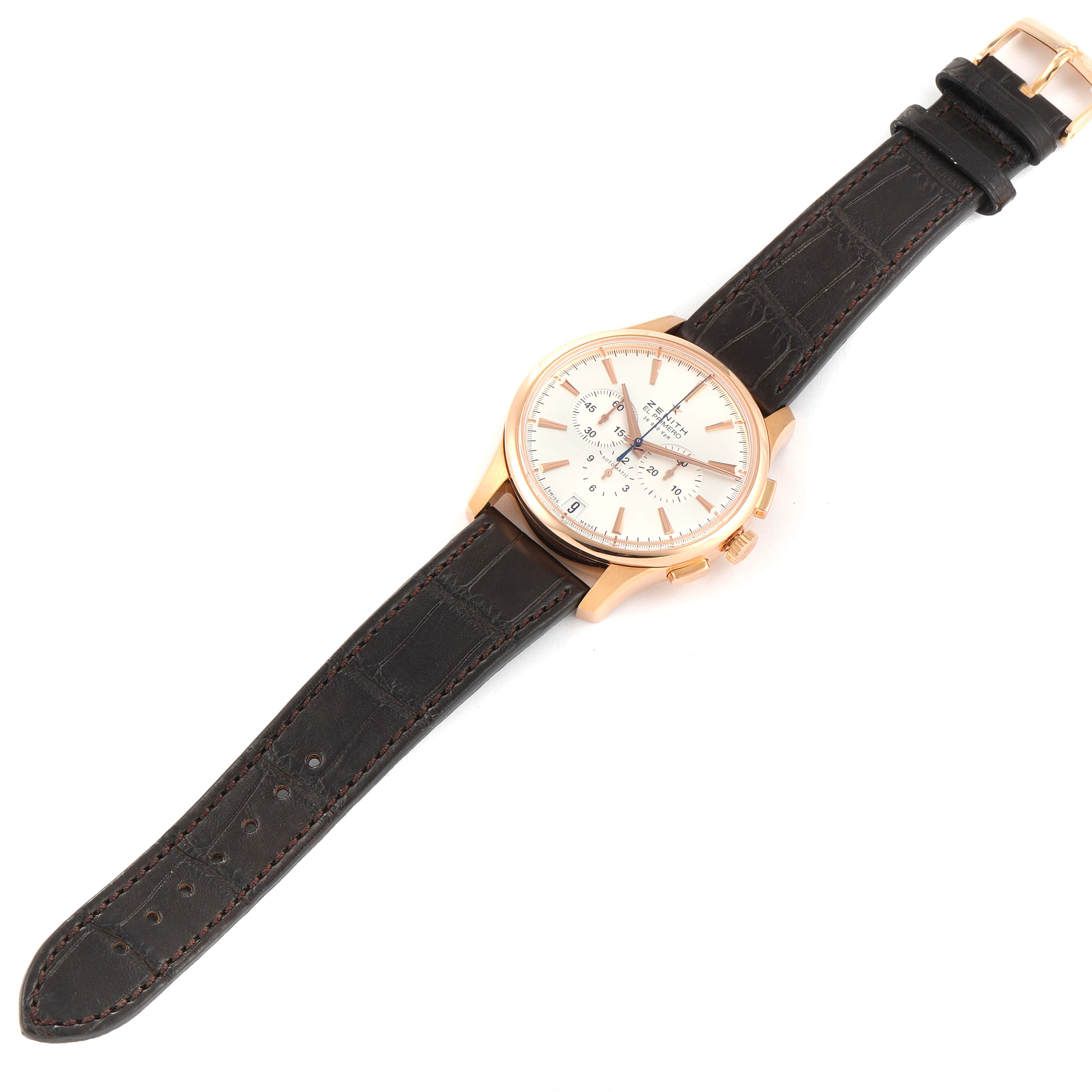 The image shows a top-down view of a Zenith El Primero 18.2110.400 Men's Rose Gold Silver Dial 18.2110.400 Men's Rose Gold Silver Dial watch with a brown leather strap and a gold case.