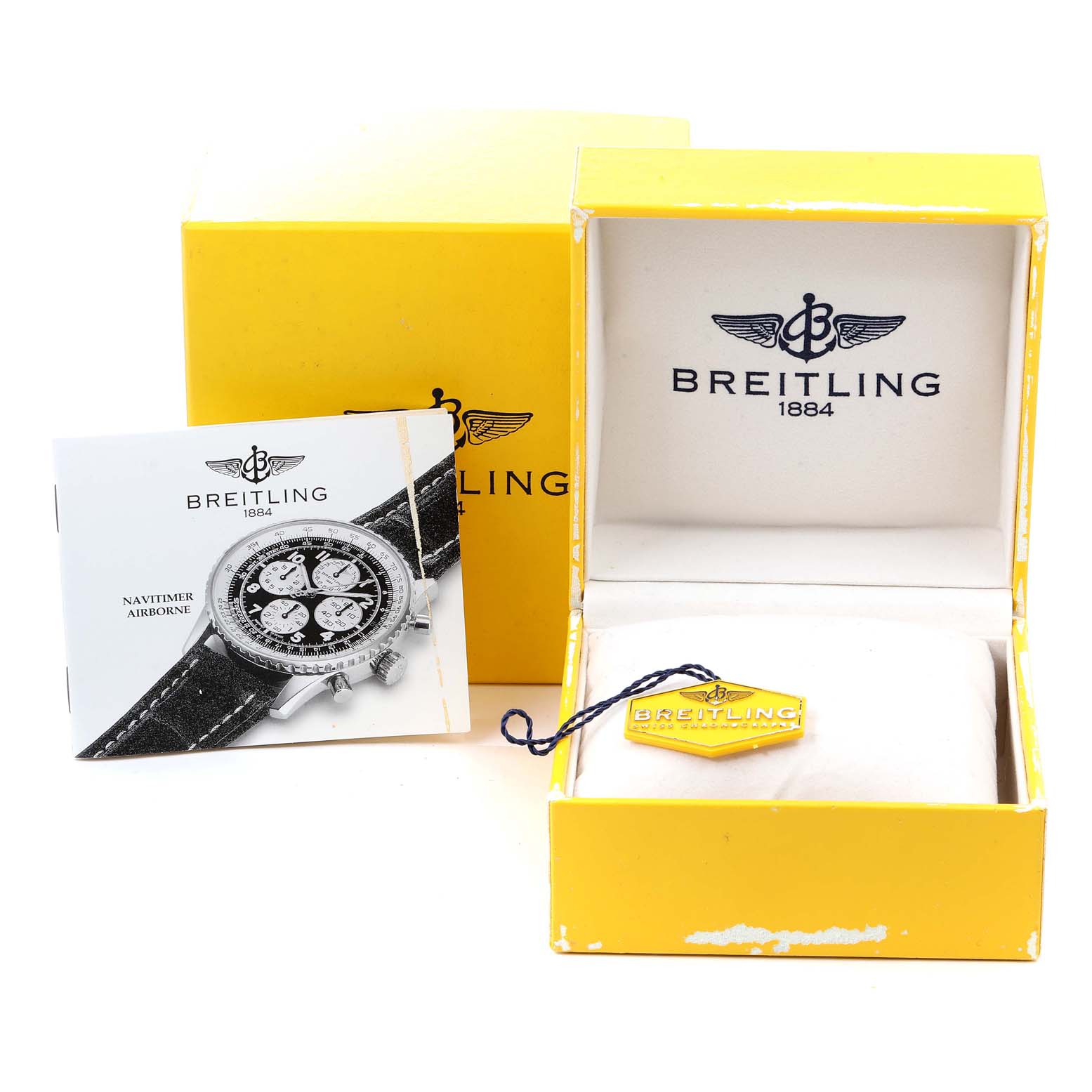 The image shows a Breitling Navitimer A33030 Men's Stainless Steel Blue Dial A33030 Men's Stainless Steel Blue Dial watch box, a tag, and a user manual in a yellow and white color scheme.