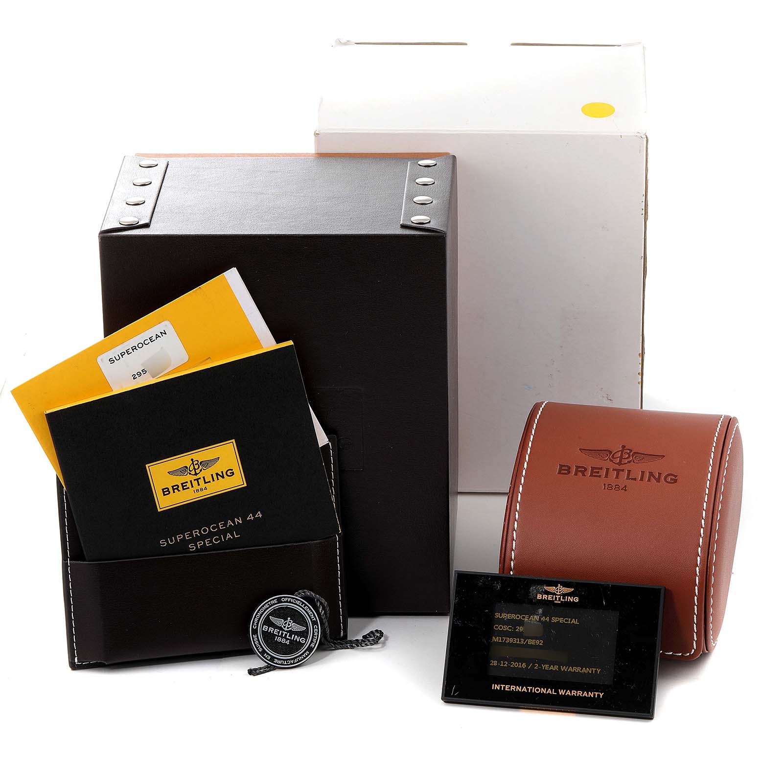 The image shows the packaging and accessories for a Breitling Superocean M17393 Men's Stainless Steel Black Dial M17393 Men's Stainless Steel Black Dial watch, including manuals, a warranty card, and a watch case.