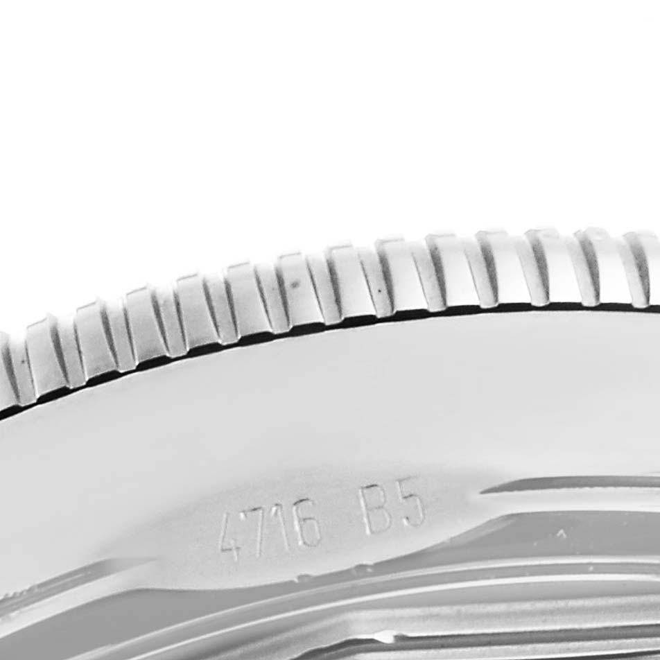 This image shows a close-up of the bezel and part of the case back of a Superocean model by Breitling.