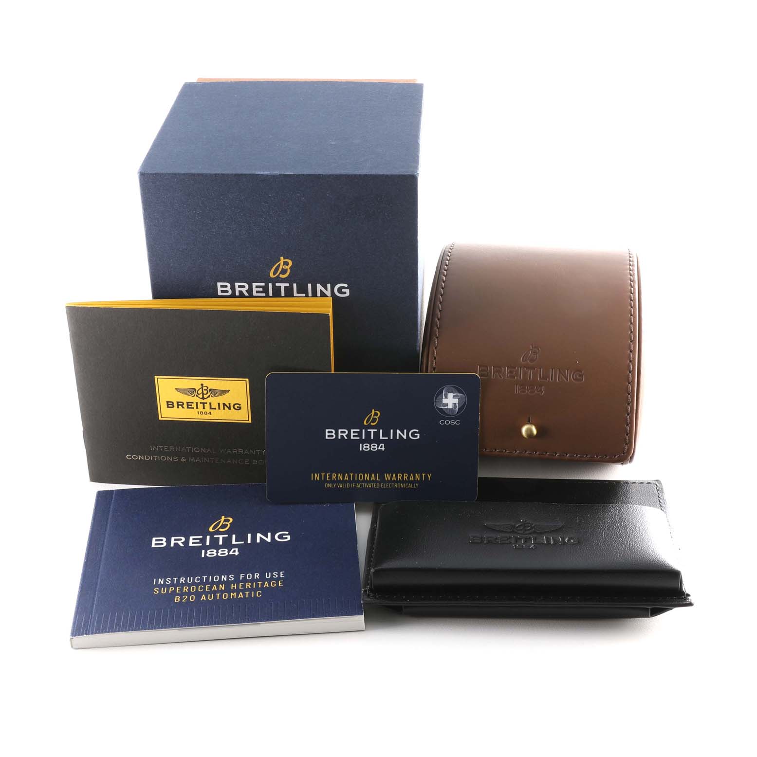 The image shows accessories for the Breitling Superocean AB2010 Men's Stainless Steel Brown Dial AB2010 Men's Stainless Steel Brown Dial model, including a box, manuals, warranty card, and leather case.