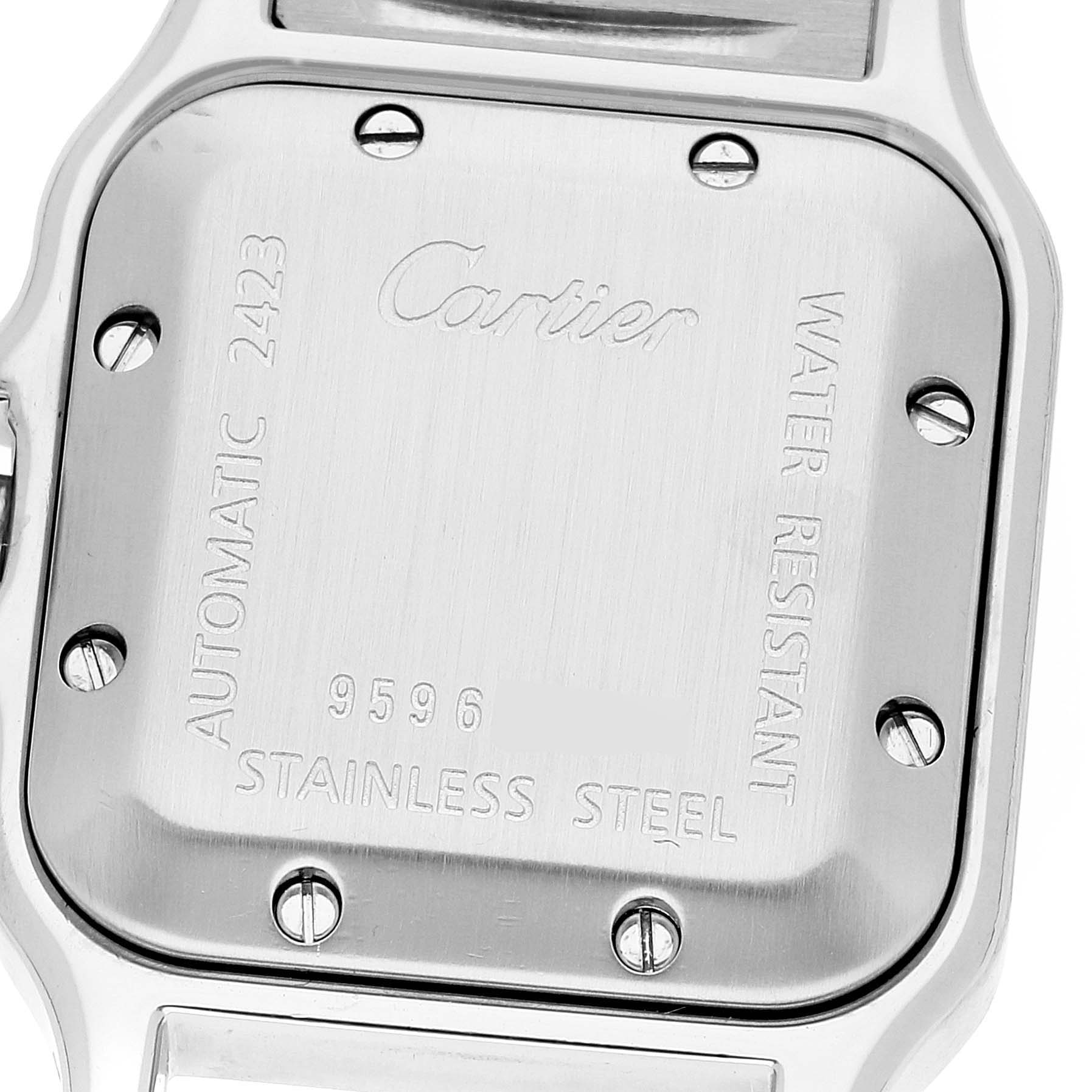 The image shows the back case of a Santos model watch by Cartier, focusing on its engravings and screws.