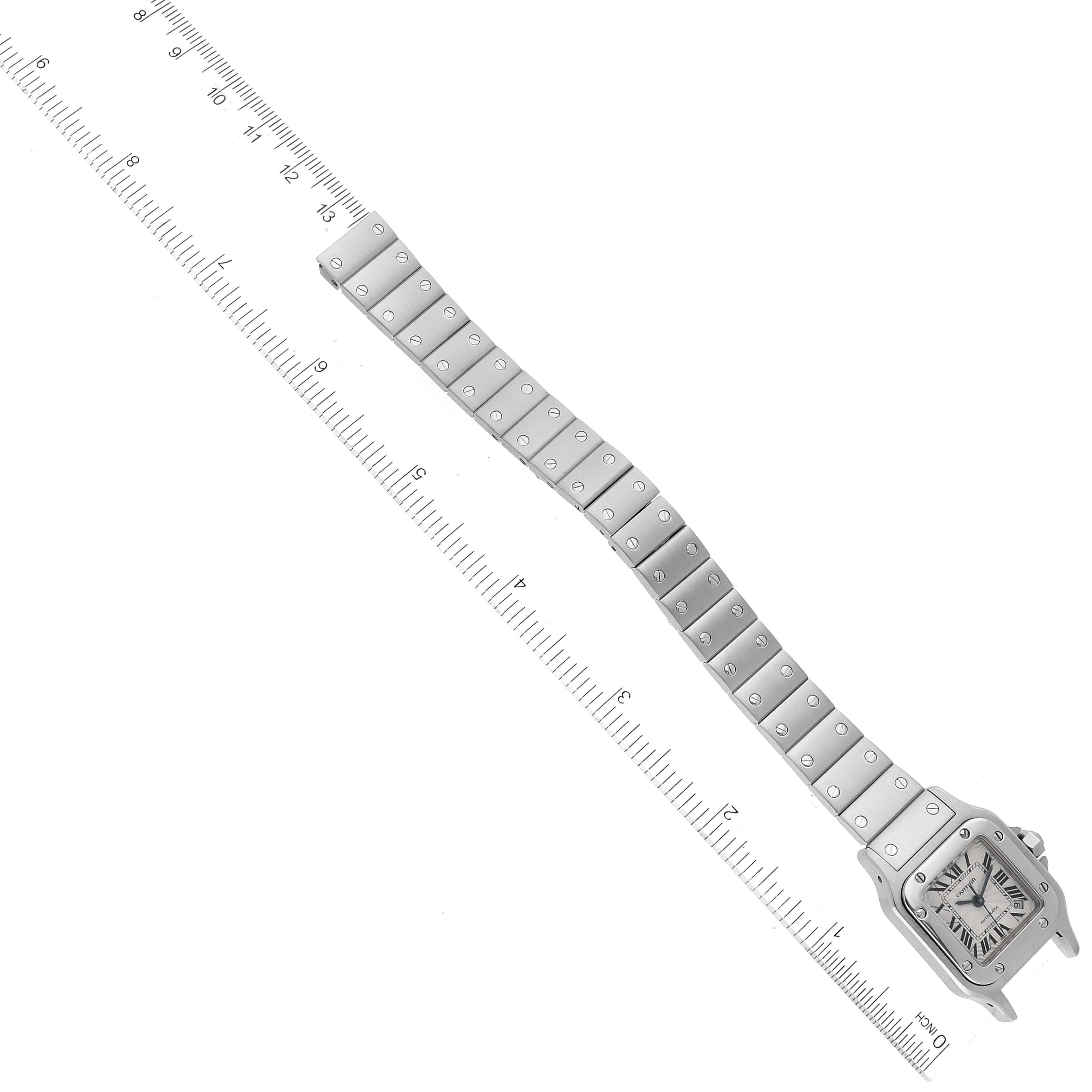 The image shows a Cartier Santos W20054D6 Women's Stainless Steel Silver Dial W20054D6 Women's Stainless Steel Silver Dial watch laid flat, highlighting the face and entire metal bracelet with a ruler for scale.