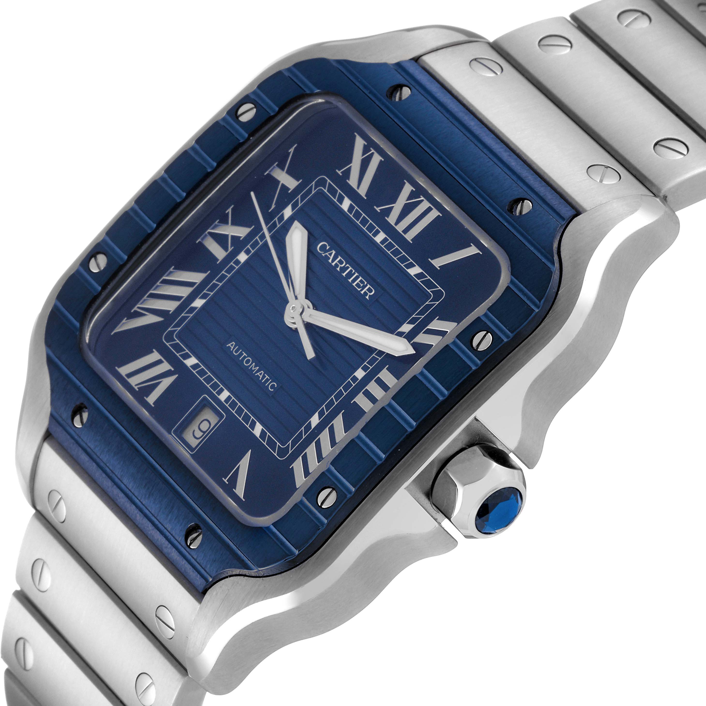 The image showcases a Cartier Santos WSSA0048 Men's Stainless Steel Blue Dial WSSA0048 Men's Stainless Steel Blue Dial model watch angled to display its face, bezel, crown, and part of the metal bracelet.
