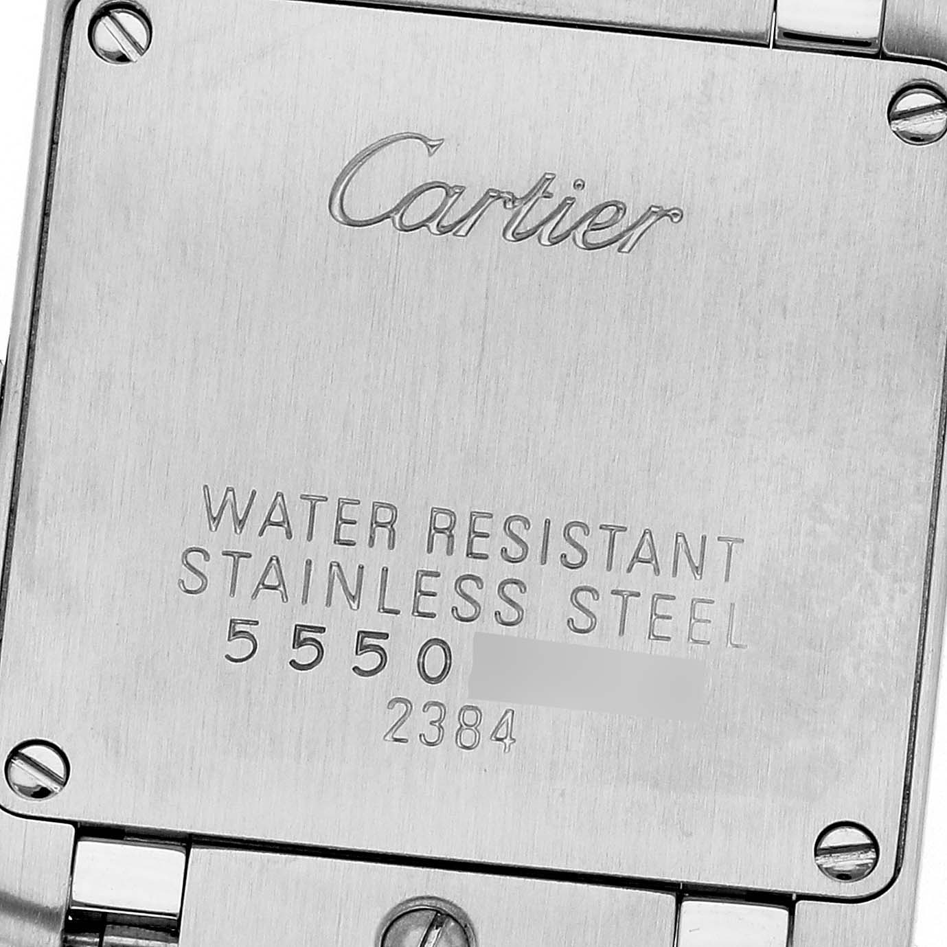 The image shows the back casing of a Cartier Tank Française watch, highlighting its engraved details.