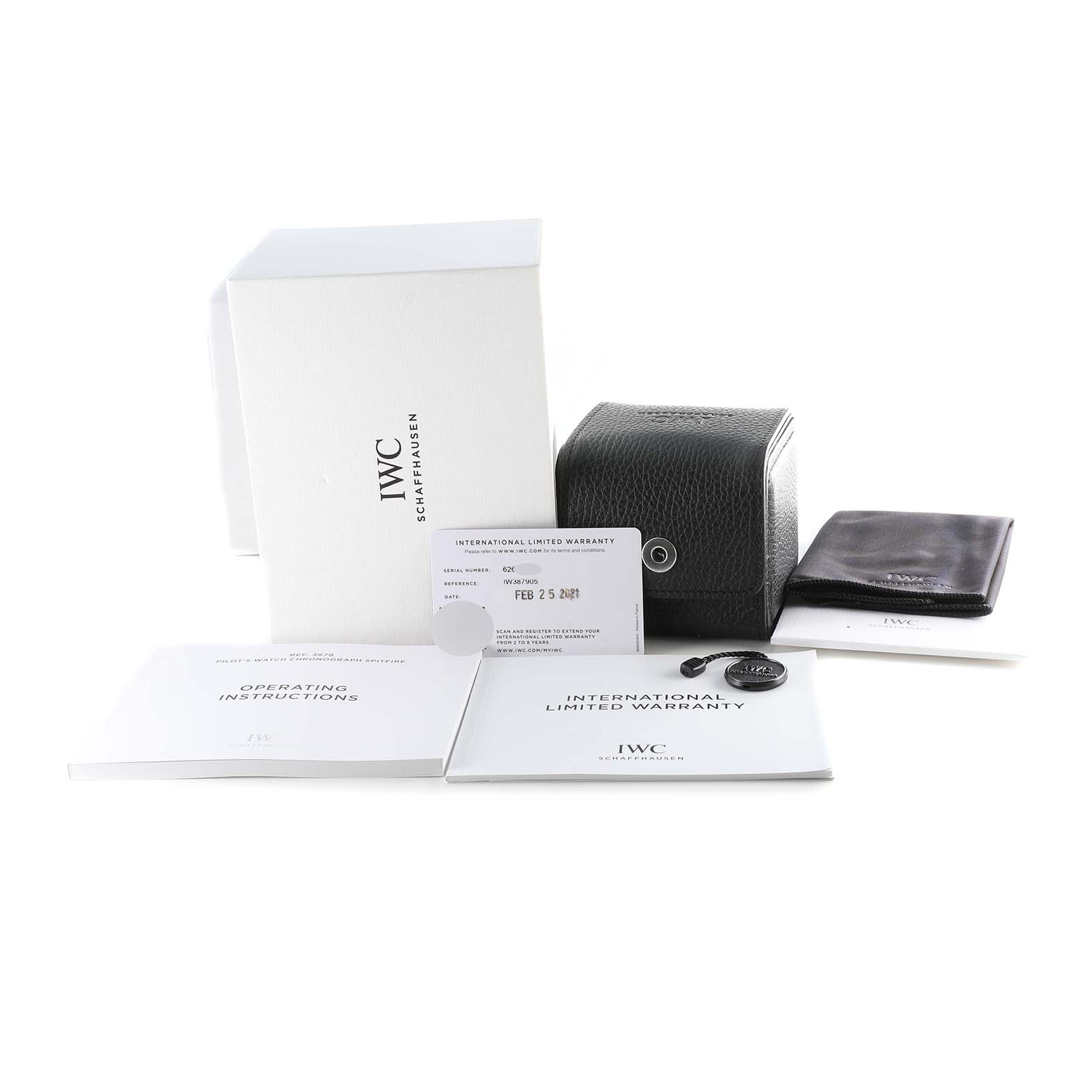 The image shows the packaging and accessories for the IWC Pilot IW387905 Men's Titanium Black Dial IW387905 Men's Titanium Black Dial model watch, including a box, warranty card, manuals, and leather case.