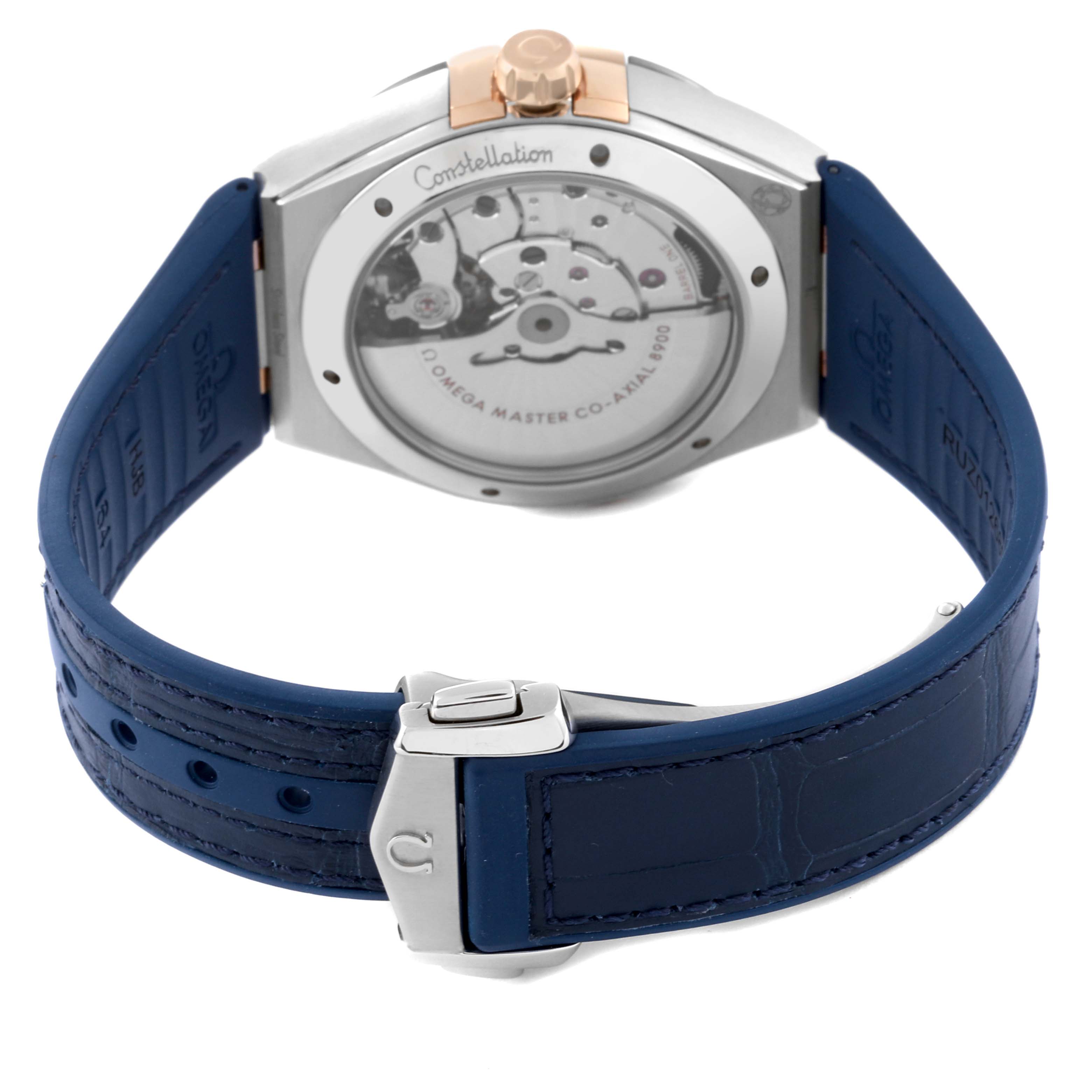 The image shows the back view of an Omega Constellation 131.23.41.21.03.001 Men's Steel and Gold (two tone) Blue Dial 131.23.41.21.03.001 Men's Steel and Gold (two tone) Blue Dial watch, highlighting its mechanical movement and blue leather strap.