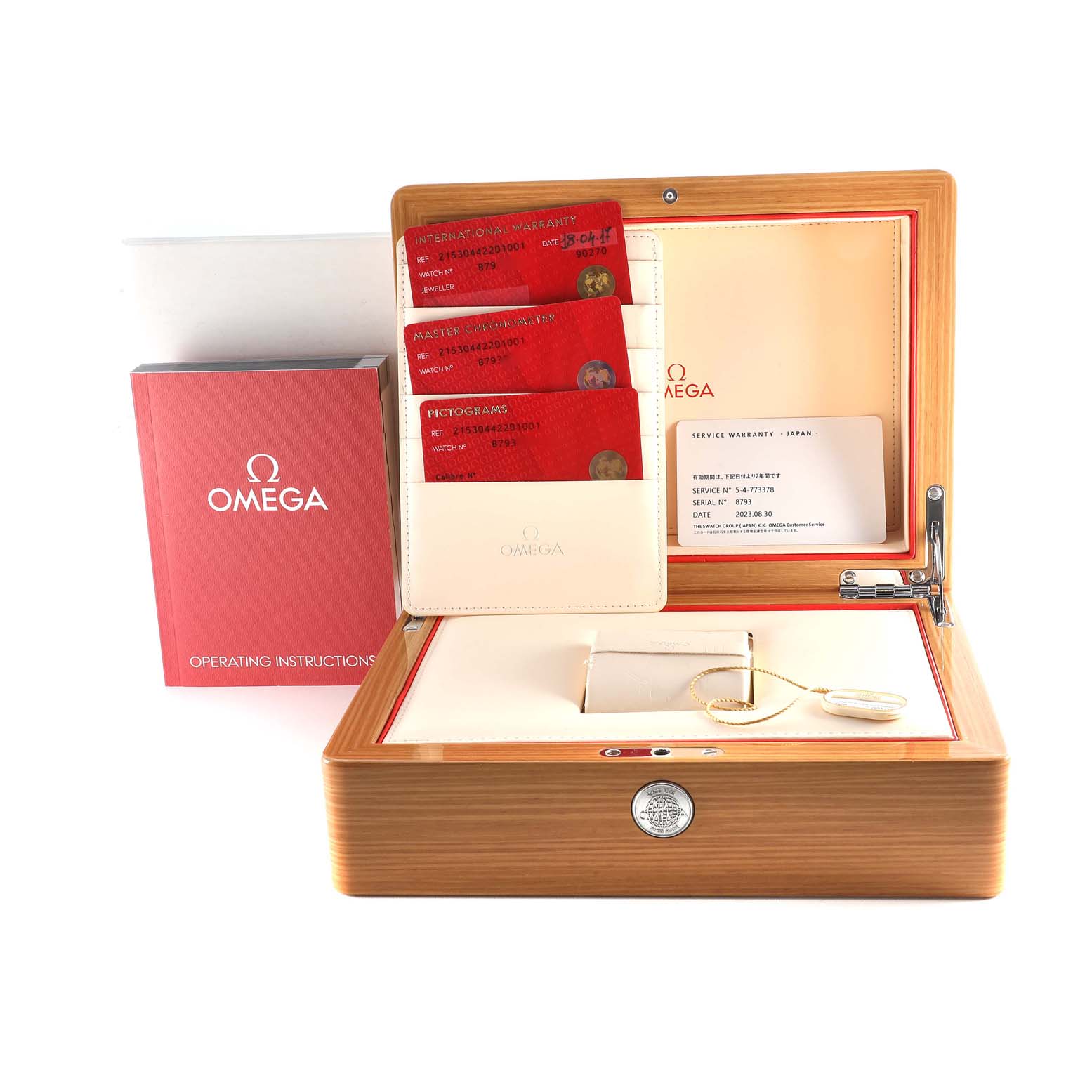 The image shows an Omega Planet Ocean 215.30.44.22.01.001 Men
s Stainless Steel Black Dial 215.30.44.22.01.001 Men
s Stainless Steel Black Dial watch box, warranty cards, and operating instructions booklet.