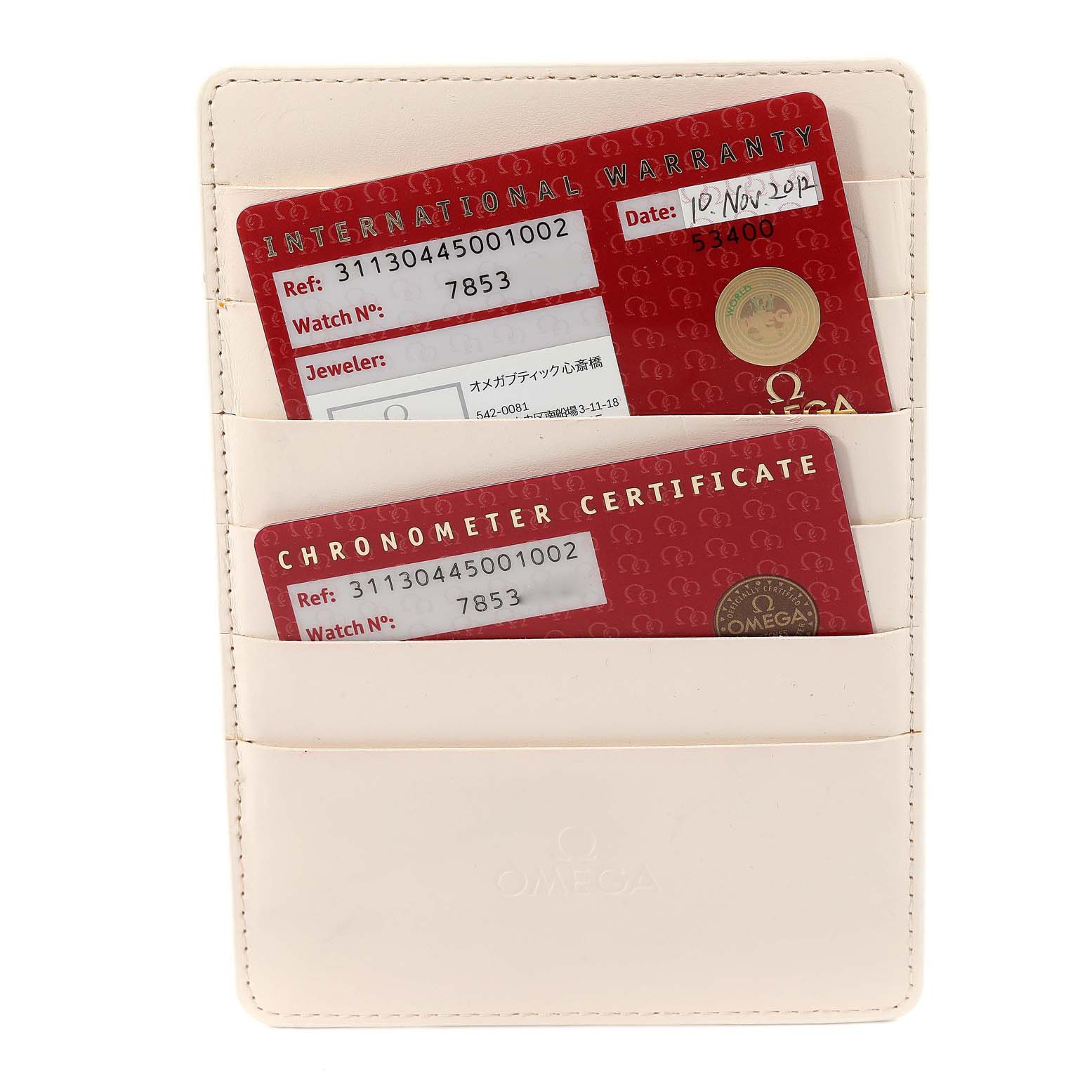 The image shows two red Omega Speedmaster 311.30.44.50.01.002 Men's Stainless Steel Black Dial 311.30.44.50.01.002 Men's Stainless Steel Black Dial cards, an International Warranty and a Chronometer Certificate, in a beige cardholder.