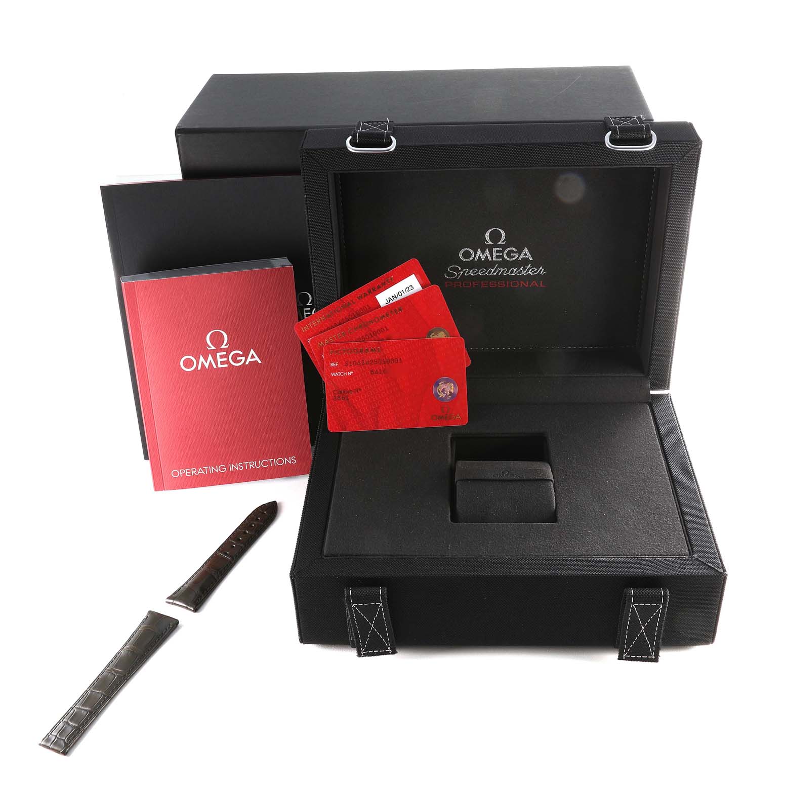 The image shows the box and accessories for the Omega Speedmaster 310.63.42.50.10.001 Men's Yellow Gold Green Dial 310.63.42.50.10.001 Men's Yellow Gold Green Dial watch, including a strap, operating instructions, and cards.