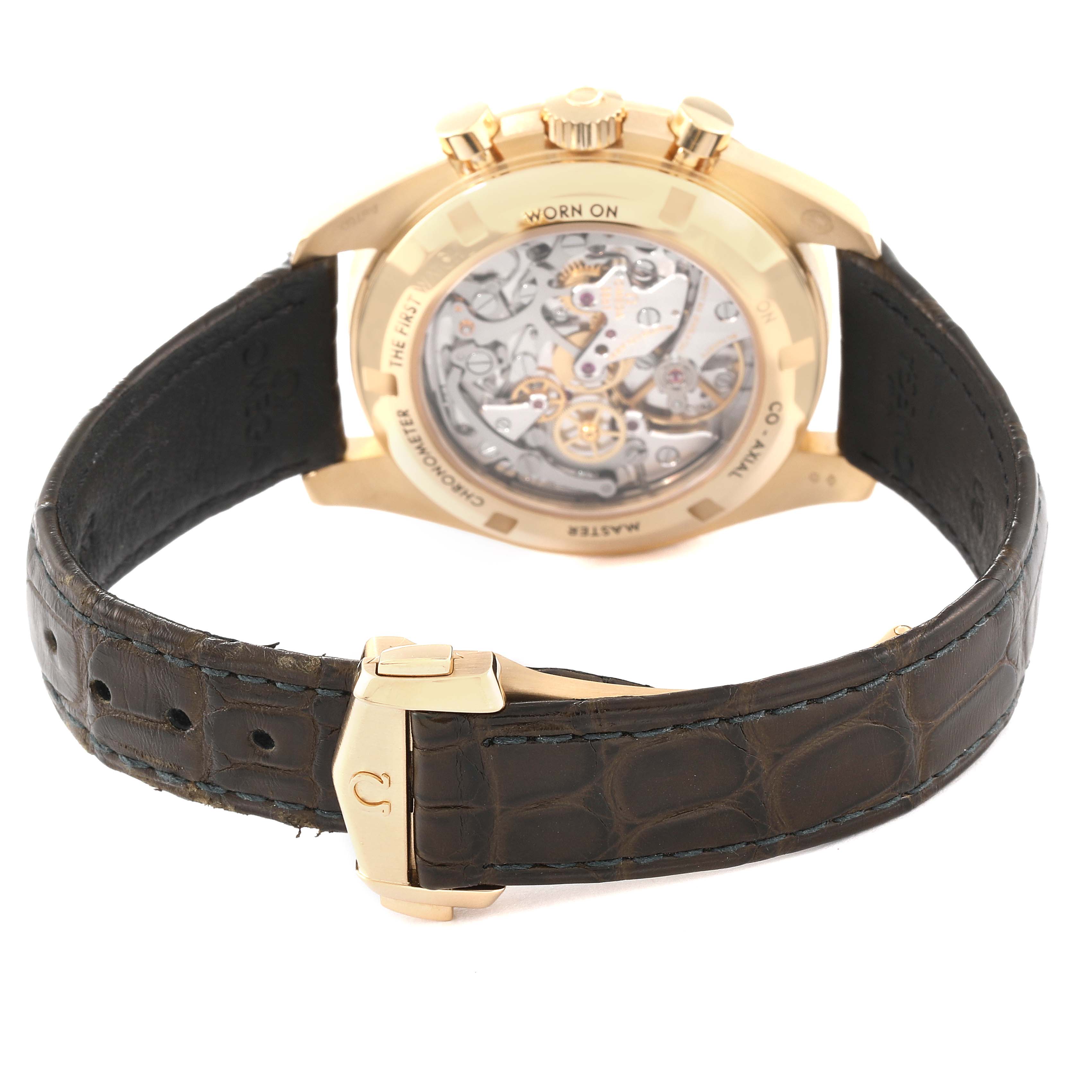 The image shows the back view of the Omega Speedmaster 310.63.42.50.10.001 Men's Yellow Gold Green Dial 310.63.42.50.10.001 Men's Yellow Gold Green Dial watch, highlighting the transparent case back and leather strap with clasp.