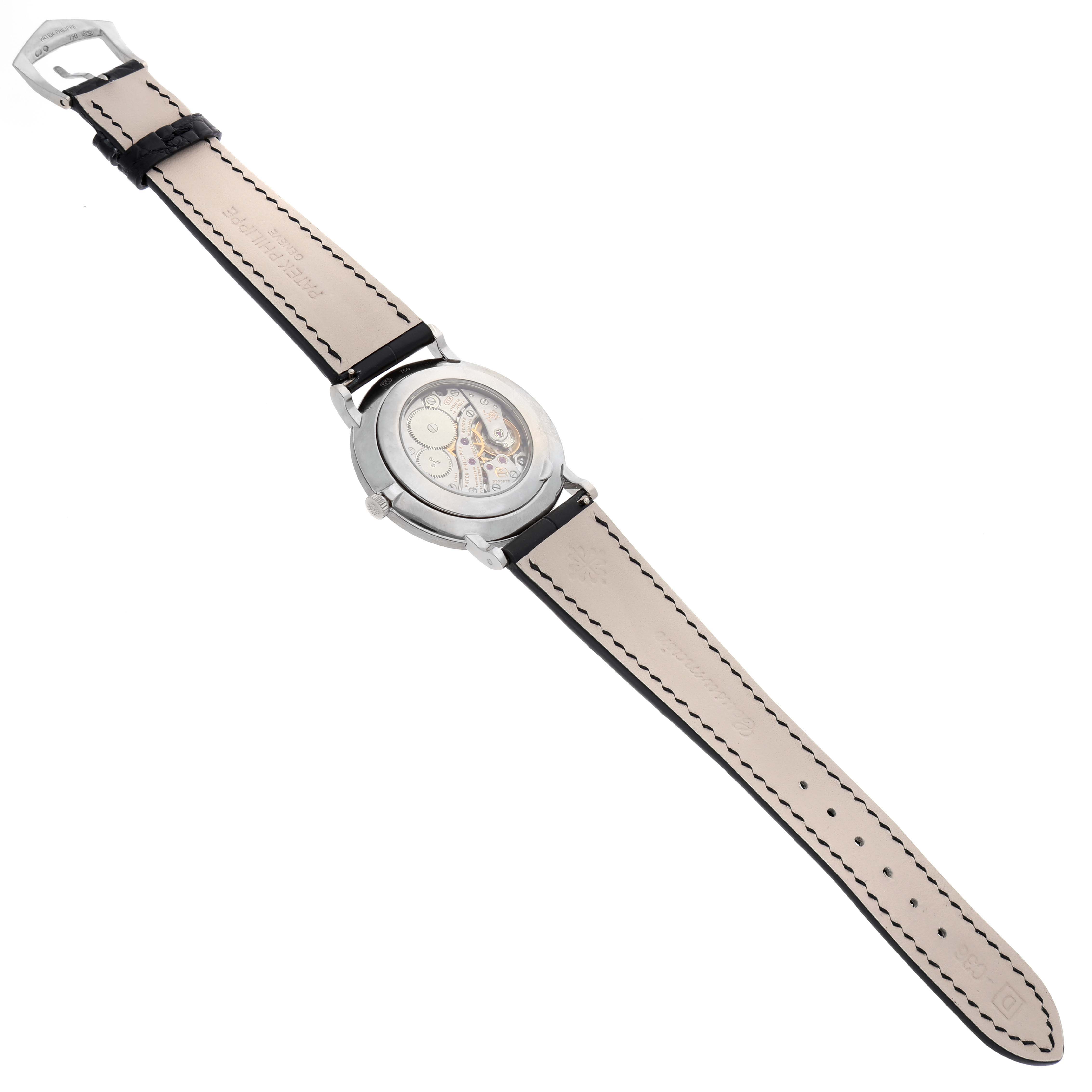 This image shows the back of the Patek Philippe Calatrava 5116G Men
s White Gold White Dial 5116G Men
s White Gold White Dial model watch, displaying its leather strap and the transparent case back revealing the movement.