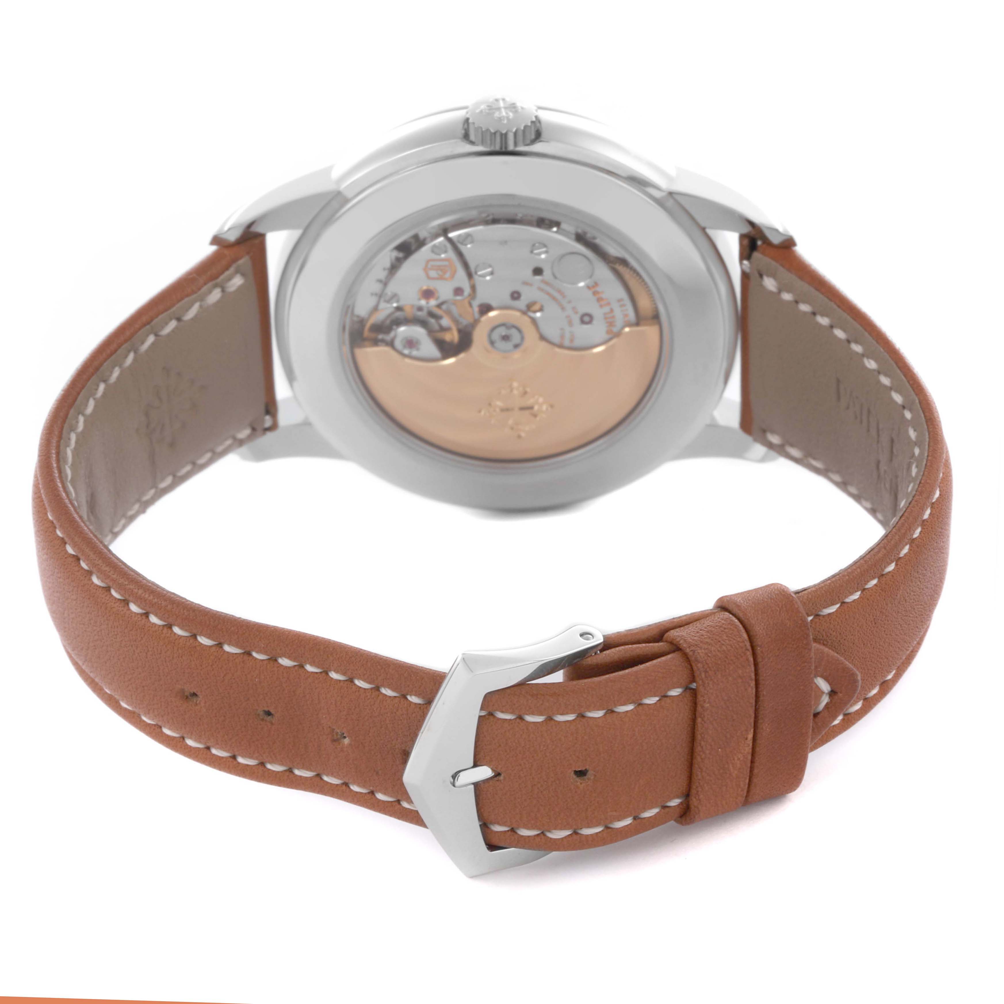 The Patek Philippe Complications 5212A-001 Men's Stainless Steel Silver Dial 5212A-001 Men's Stainless Steel Silver Dial watch is shown from the back, displaying its mechanical movement and brown leather strap.