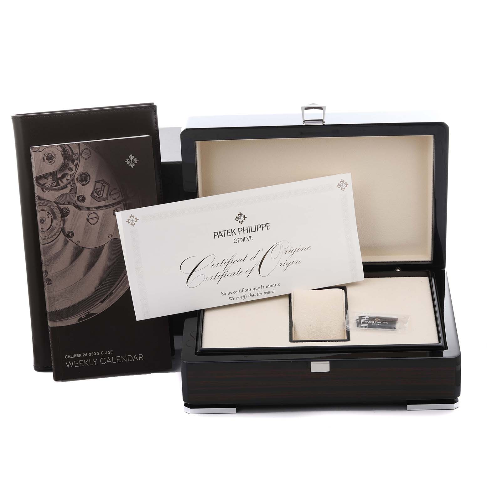 The image shows a Patek Philippe Complications 5212A-001 Men's Stainless Steel Silver Dial 5212A-001 Men's Stainless Steel Silver Dial watch box, certificate of origin, and booklet from a top-front angle.