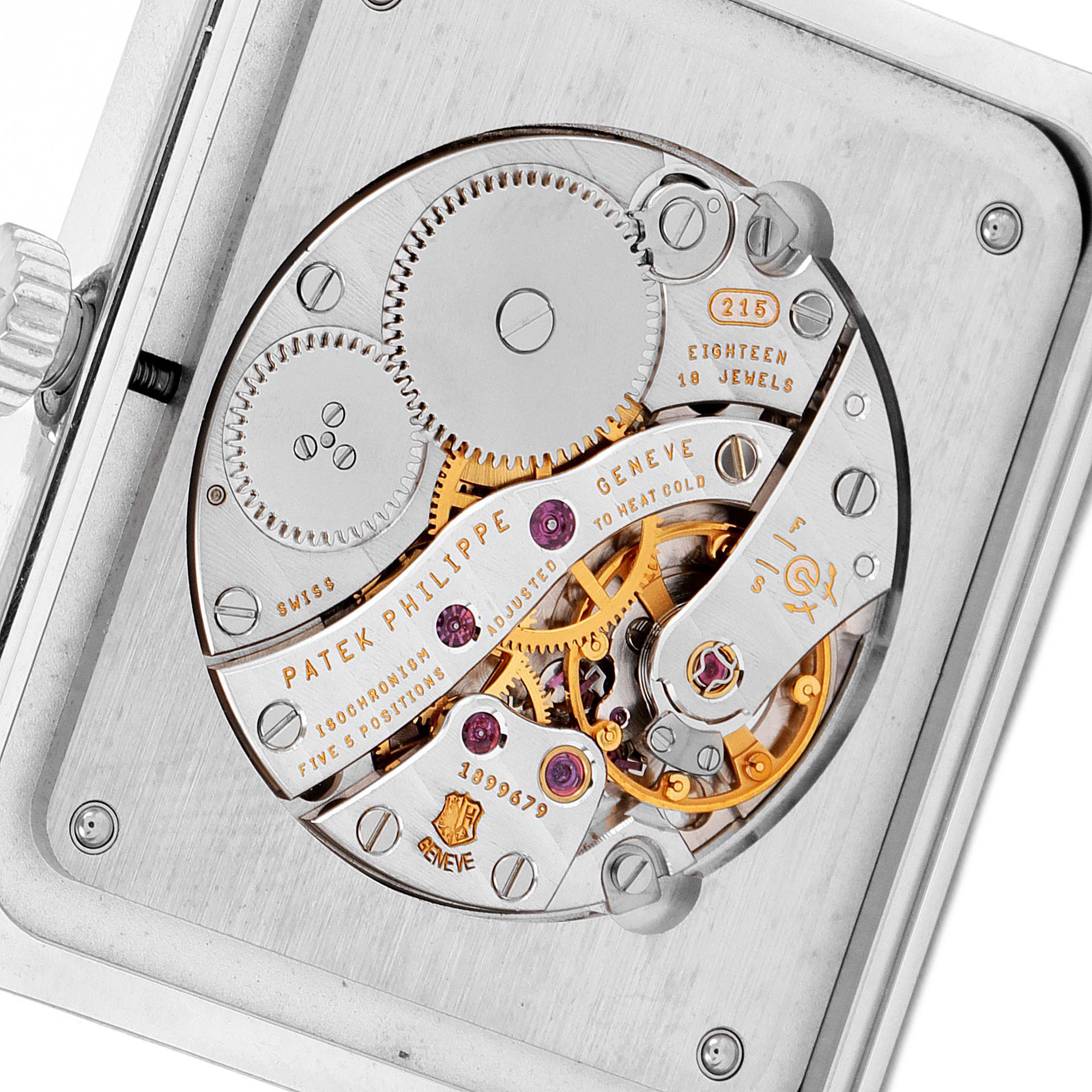The image shows a detailed view of the Patek Philippe Gondolo 5109G Men's White Gold Silver Dial 5109G Men's White Gold Silver Dial's movement, highlighting gears and inscriptions.