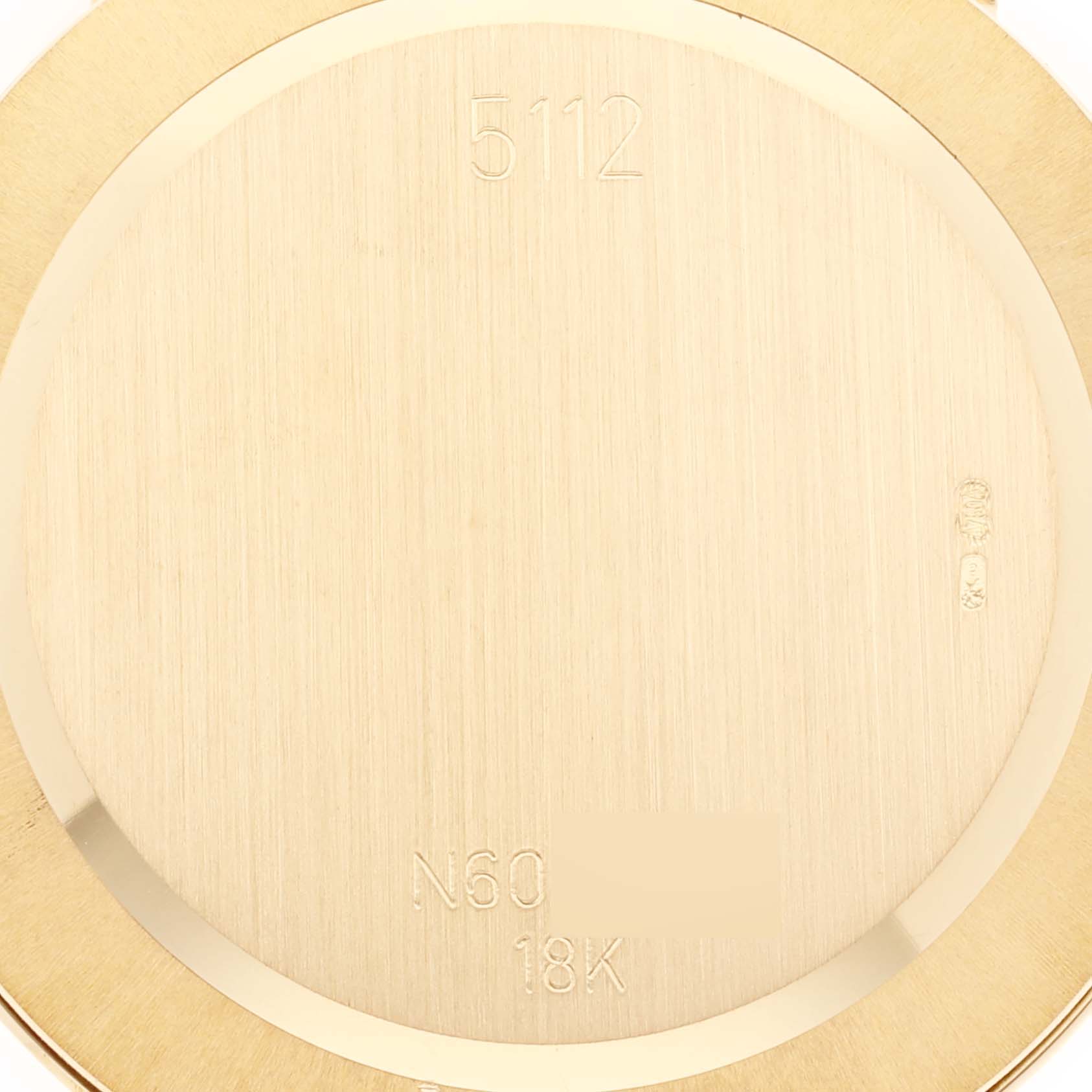 This image shows the back case of the Rolex Cellini 5112 Men's Yellow Gold White Dial 5112 Men's Yellow Gold White Dial model, displaying its material and engravings.