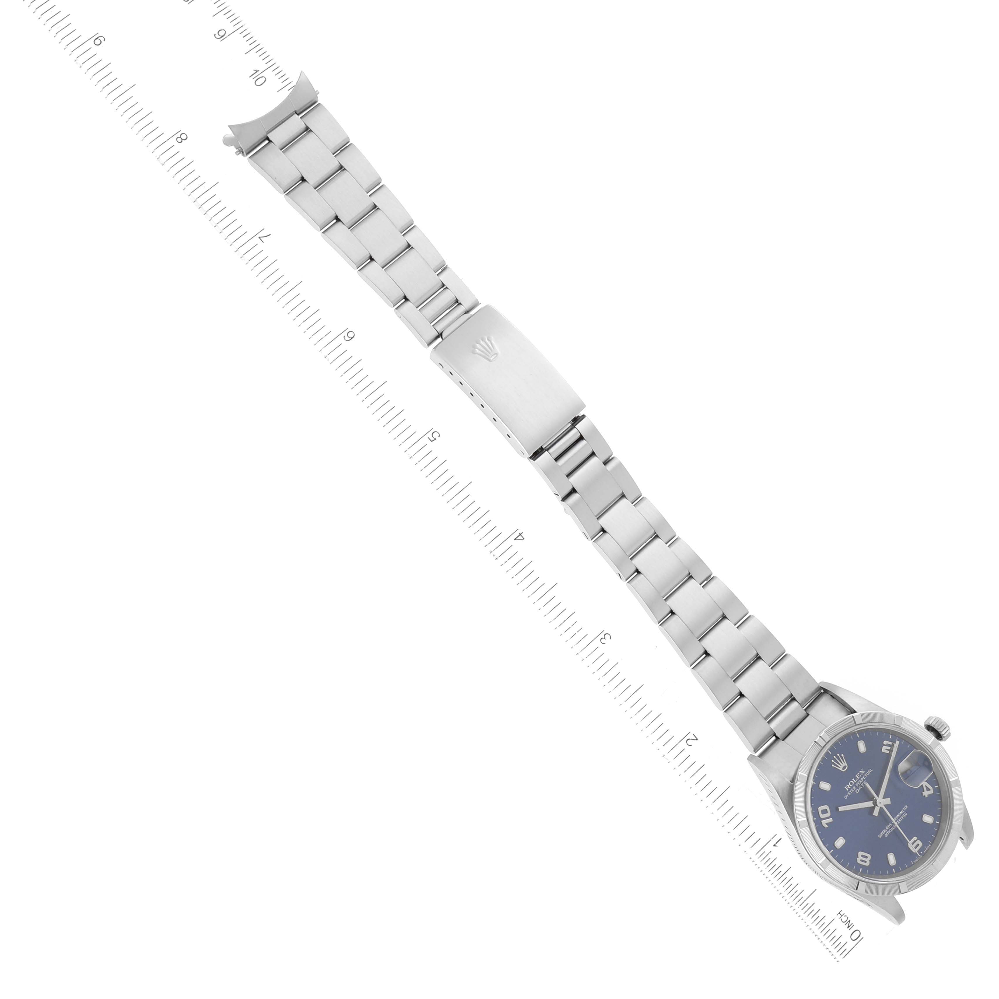 The image shows a Date model Rolex watch laid flat with the full bracelet and a ruler for scale.