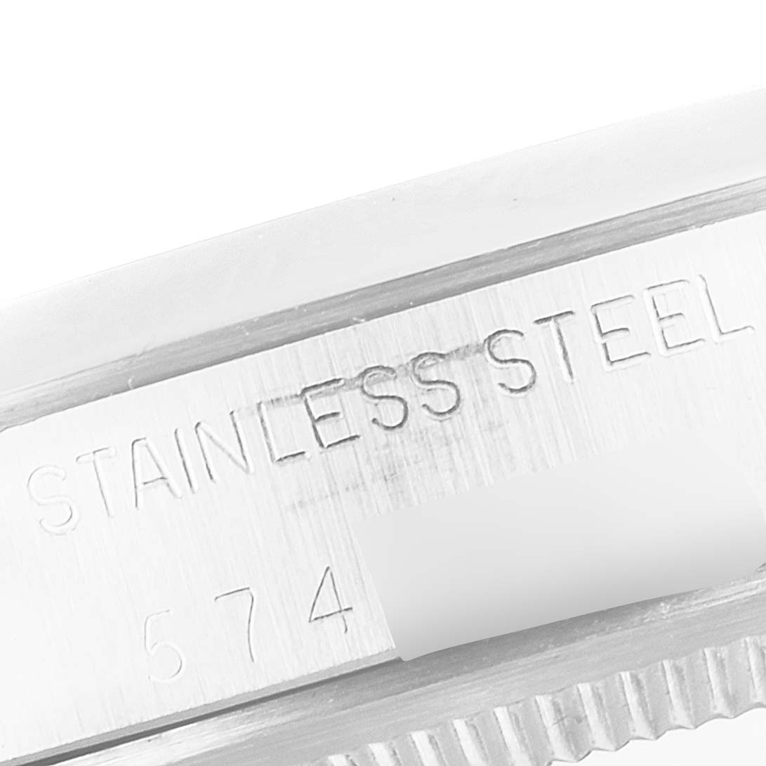 This image shows a close-up of the case side of a Rolex Vintage Collection 1500 Men's Stainless Steel Grey Dial 1500 Men's Stainless Steel Grey Dial model, highlighting "Stainless Steel" engraving.